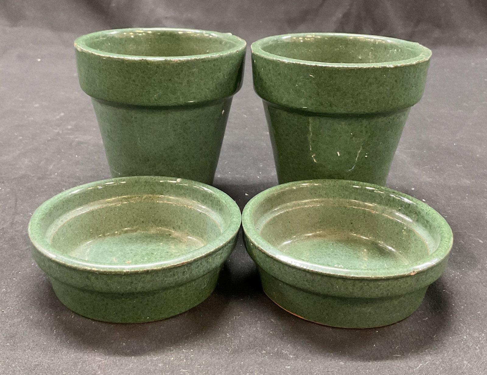 Set 4 Vintage Green Ceramic Planter Pots: Set of 4 vintage green ceramic planter pots. Marked on underside, reads illegibly. Green glazed with glossy finish. Shape and size vary. Largest measures ht approx 3.5 inches diam approx 3.5 inches. S
