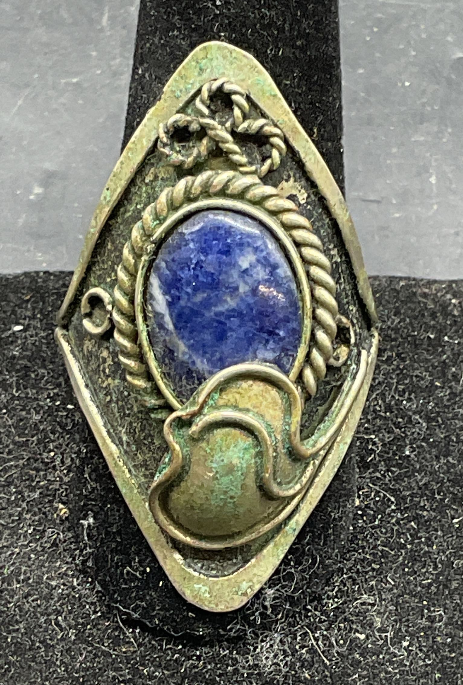 Silver Tone Blue Cabochon Cocktail Ring: Vintage silver tone cocktail ring with blue stone cabochon. Adjustable band. Setting measures approx. 1.75 inches long. Some scratching. Jewelry, estate jewelry, costume jewelry, cocktail jewelry, fas
