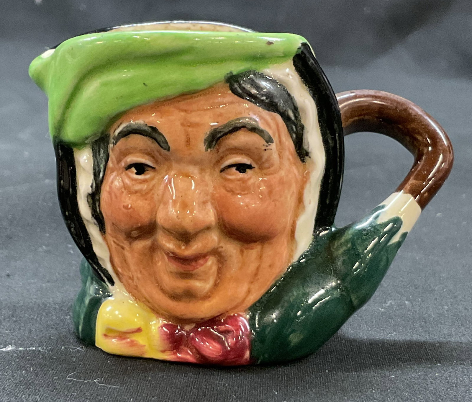 Royal Doulton Sairey Gamp Ceramic Creamer England: Royal Doulton Sairey Gamp ceramic creamer. Marked on underside, reads Made In England Royal Doulton. Marked Sairey Gamp on surface. Depicts the character Sairey Gamp from Charles Dickens novel Martin 