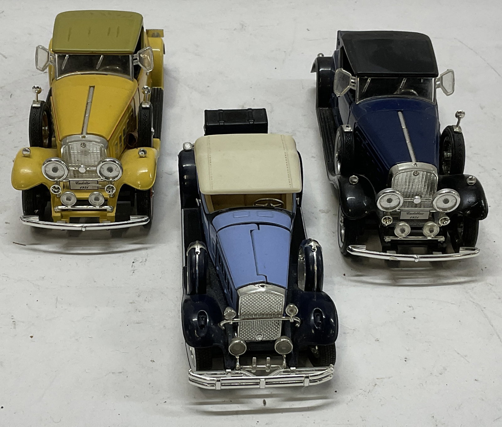 Lt 3 Signature and Cadillac Diecast Model Cars: 3 Diecast Model Cars. Includes a Yellow 1931 Cadillac Roadster Made Exclusively for National Motor Museum Mint in 2004, a Dark Blue 1931 Cadillac Roadster Made 2004, and a Two-Toned Blue Signature 193