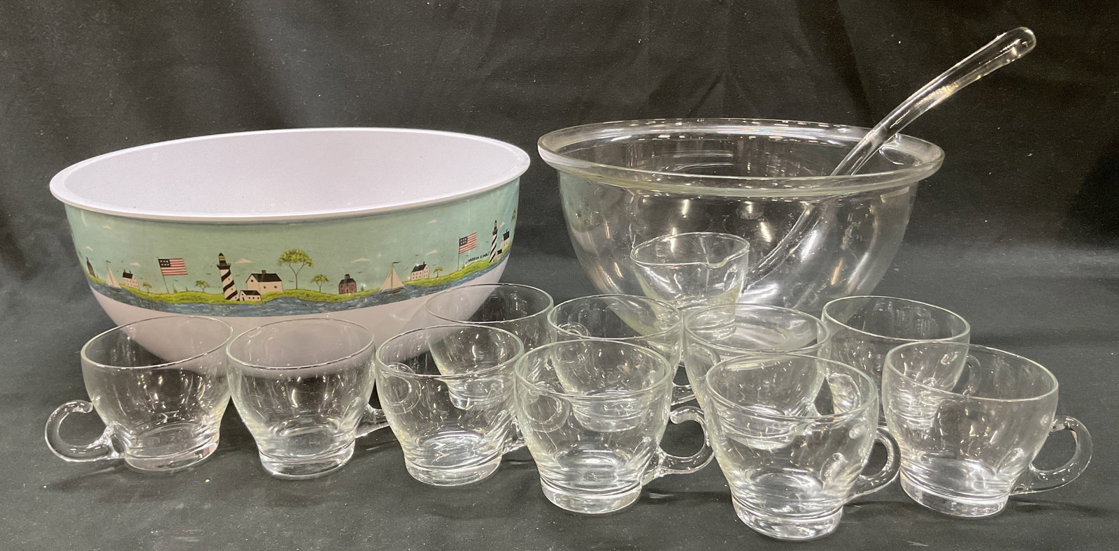Lot 13 Vintage Glass Assorted Tableware: Lot of 13 assorted tableware items. Sakura Evolution plastic serving bowl/punch bowl, marked on underside. Features flag, architecture, water, grass, and more motifs. Marked Warren Kimble. Glass servi
