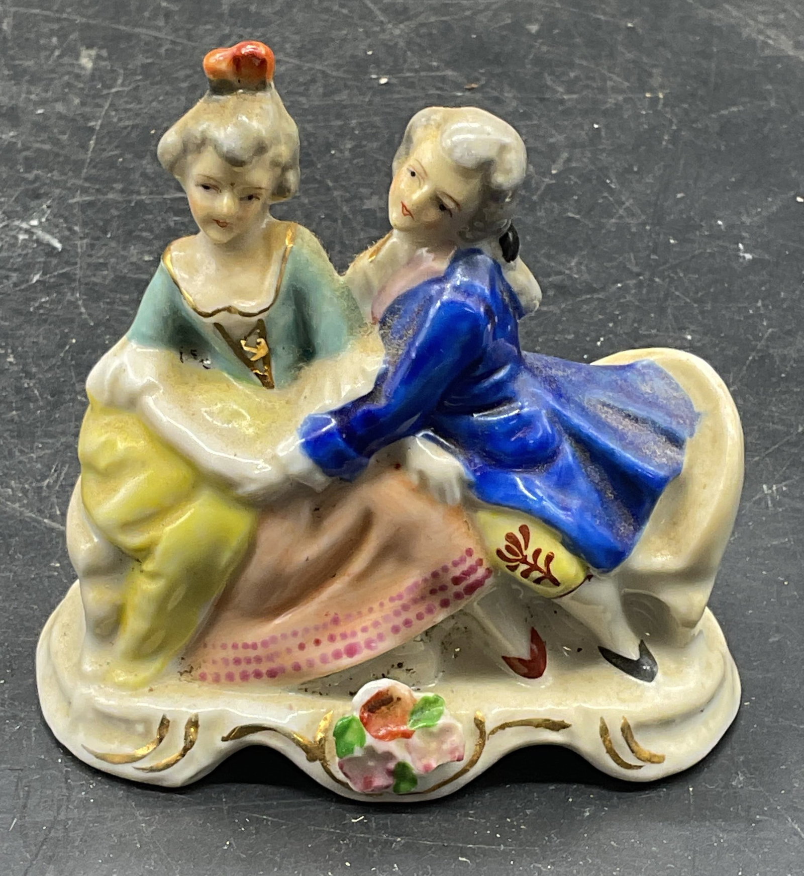 Porcelain Courting Couple Figurine Occ Japan: Vintage porcelain courting couple figurine. Hand painted. Made in Occupied Japan. Measures approx. 3.75 x 2 x 3.5 inches. Some scratching. Courting couple figurine, porcelain figurine, collectibles, h