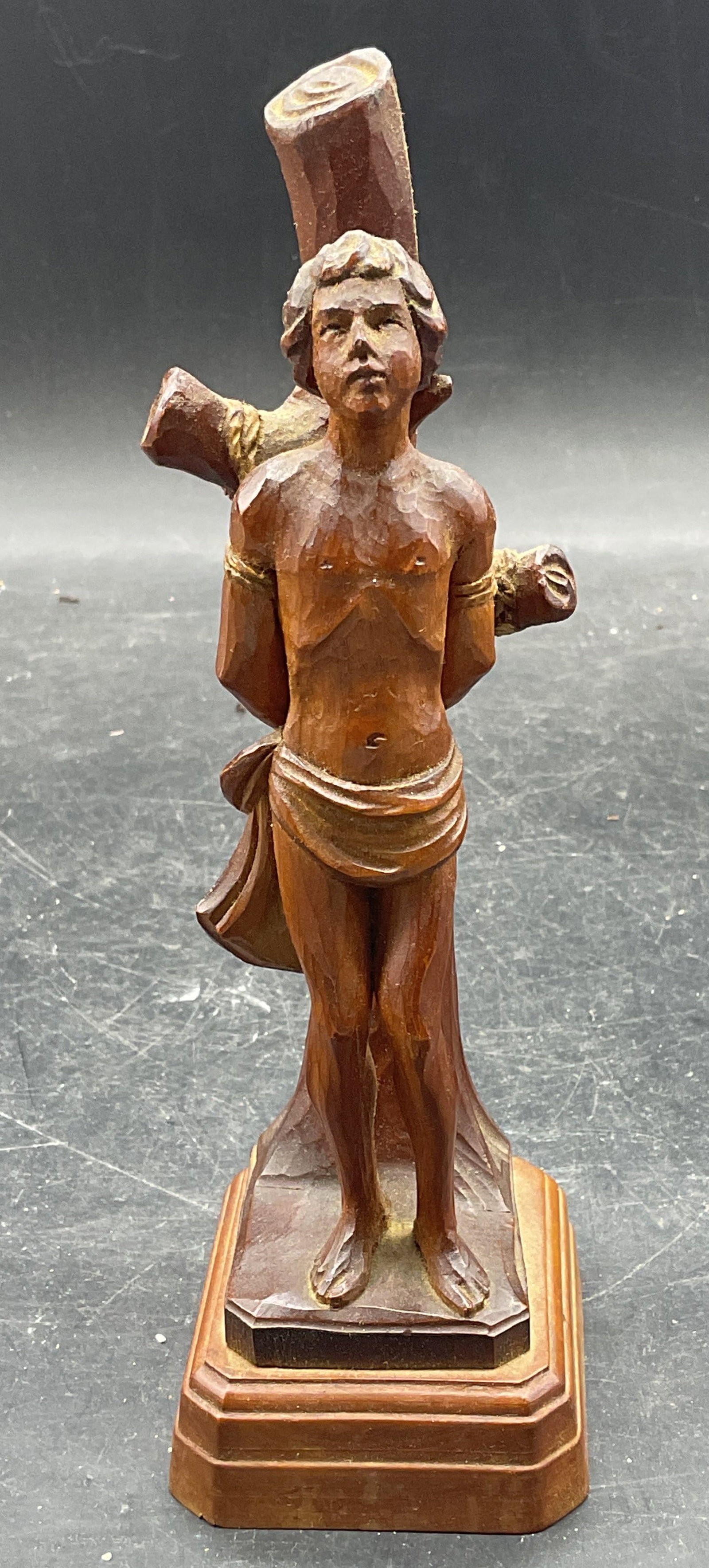 Hand Carved Wood Saint Sebastian Statue: Hand carved wood statue depicting Saint Sebastian tied to a tree. Measures approx. 2.25 x 2.75 x 7.5 inches. Some scratching. Saint Sebastian statue, carved wood statue, home decor, home accessories, 