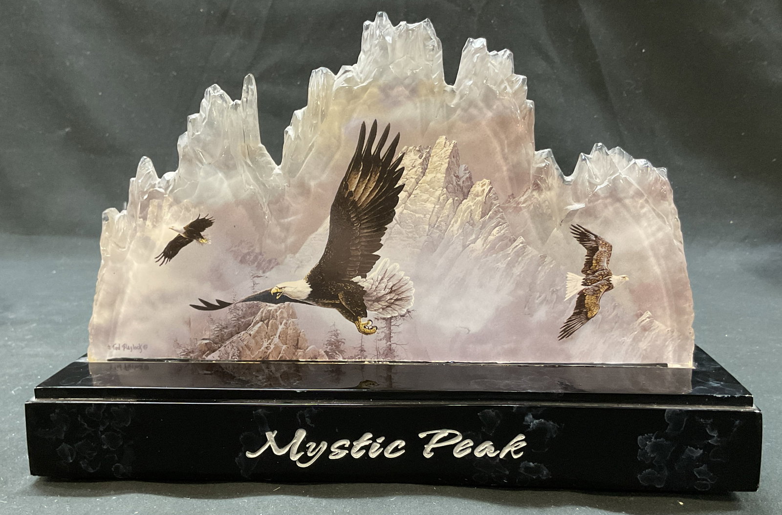 2007 Bradford Exchange Mystic Peak Eagle Sculpture: 2007 Bradford Exchange Mystic Peak Eagle sculpture. Marked on underside as photographed here. Black rectangular base. Reads Mystic Peak. Imagery of eagles on a cut out mountain side figure. Varying co