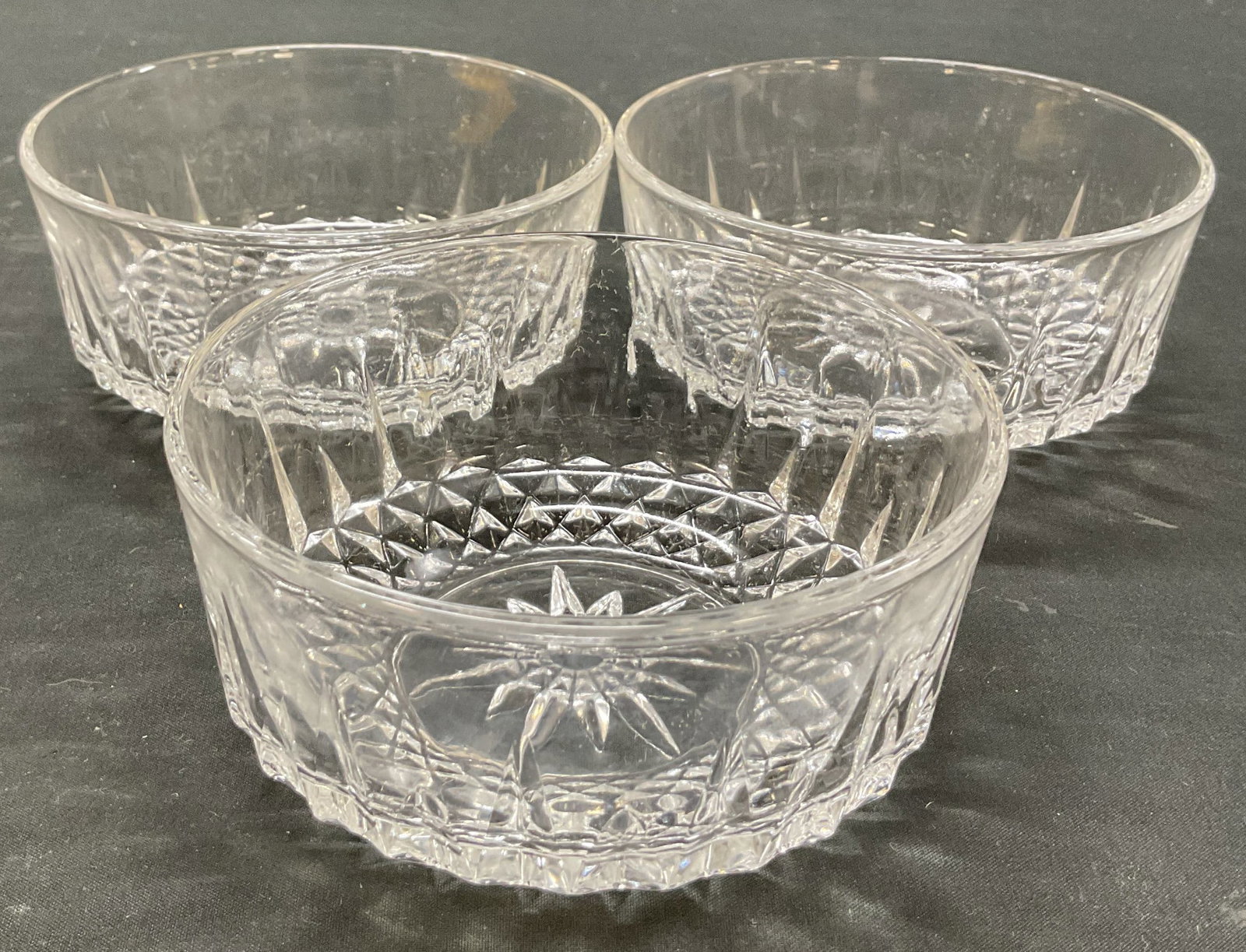Set 3 Arcoroc Glass Dishes France: Set of 3 Arcoroc glass dishes. Marked Arcoroc France on underside. Round dish. Cut diamond and starburst motifs. Measures ht approx 2.5 inches diam approx 5 inches. Small chip and scratching. Dish,