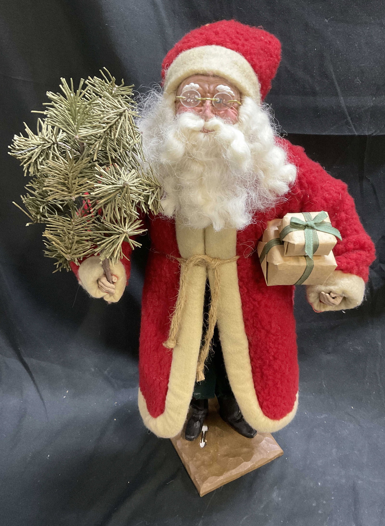 Vintage-Style 21in Santa Claus Figurine on Stand: Vintage-Style Santa Claus Figurine on Stand. Made of Resin with Fuzzy Red Wool Coat. Holds a Christmas Tree and Presents. Measures app 21in H x 5in Stand. One Foot is Loose on Stand. Missing Ball Acce