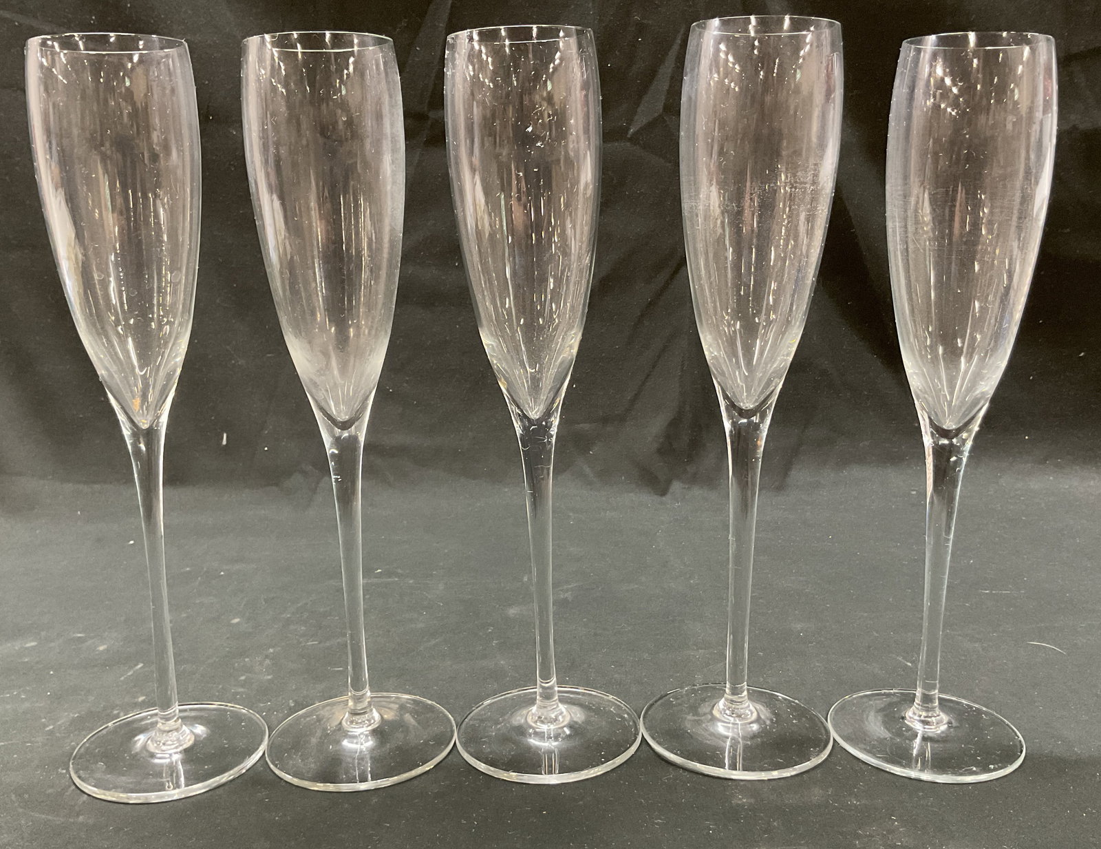 Set 5 Vintage Crystal Champagne Flutes: Set of 5 vintage crystal champagne flutes. Round base and tall stem. Tall slender body. Measures ht approx 10 inches base diam approx 3 inches. Some scratching. Champagne flutes, stemware, barware, ta