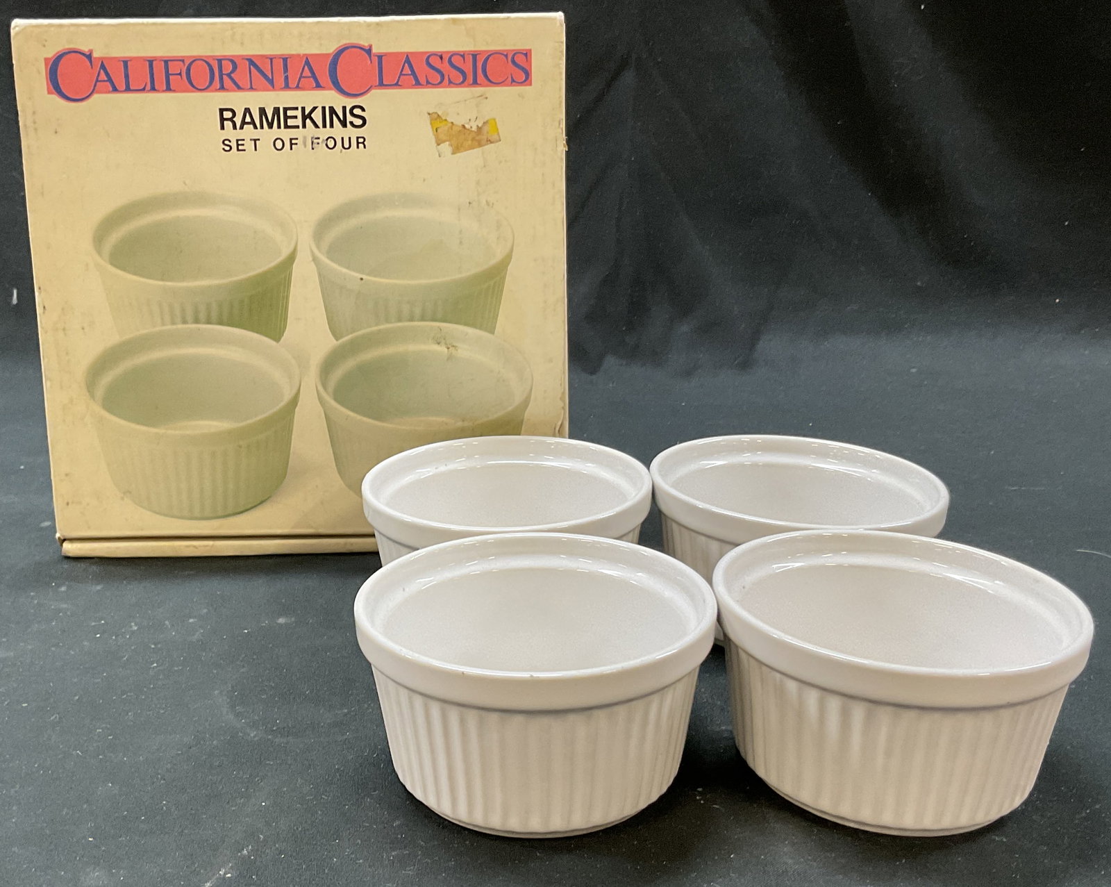 Set 4 California Classics Ramekins Japan W Box: Set of 4 California Classics stoneware ramekins. Made in Japan. Comes in original box. Round dishes with ribbed surface. Measures ht approx 2 inches diam approx 3.5 inches. Surface wear consistent wit