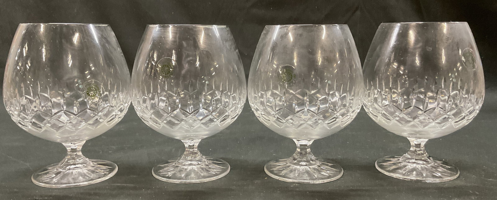 Set 4 Galway Crystal Brandy Snifters Ireland: Set of 4 Galway crystal brandy snifter. Marked Galway on underside. Sticker adhered to surface reads Galway Irish Crystal. Round base and faceted stem. Bulbous body. Cut geometric pattern. Measures