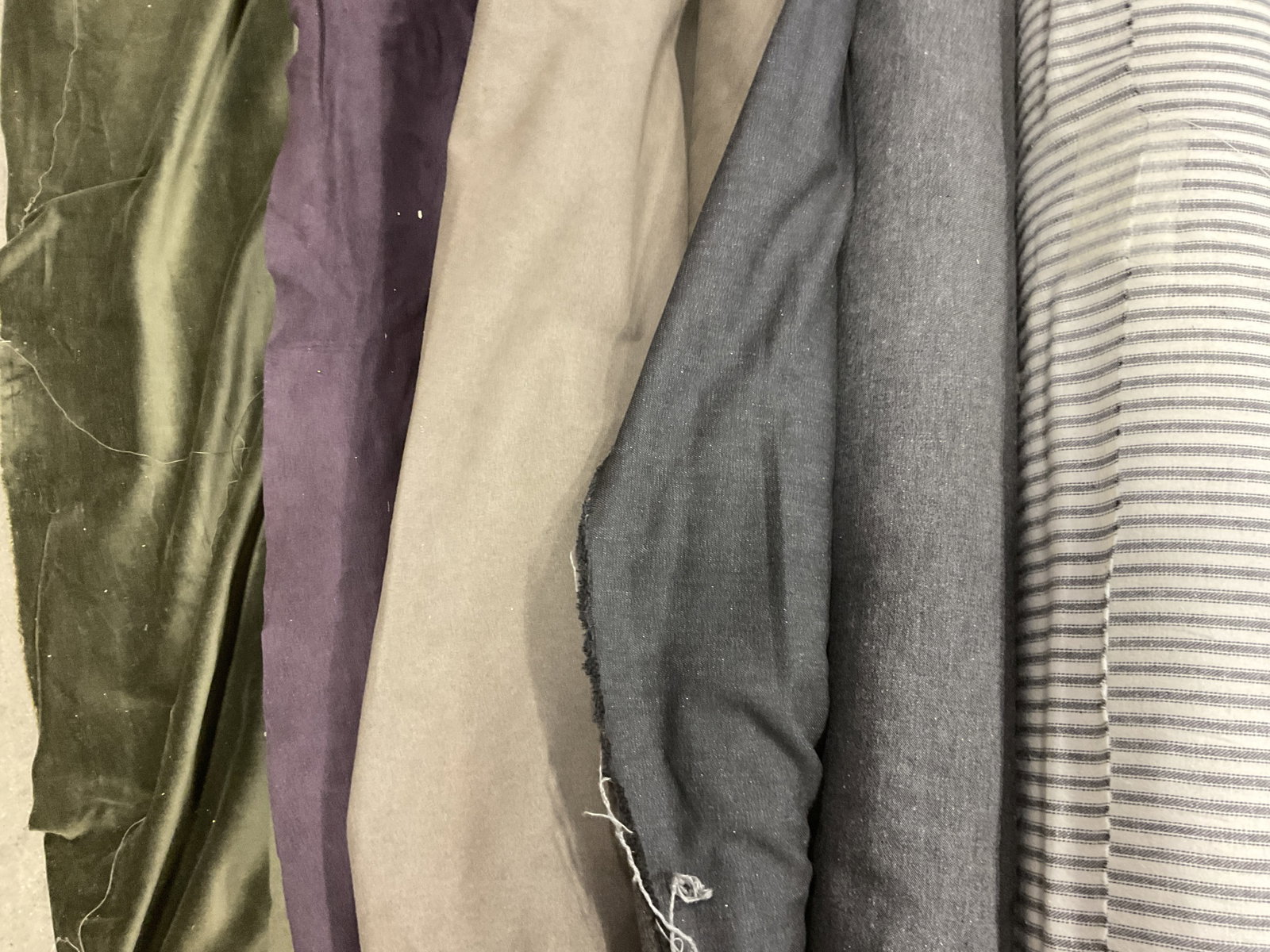 Lt 5 Dark Solid & Striped Bolts of Fabric: Lt 5 Dark Solid and Striped Bolts of Fabric. Mixed Materials. Wool, Suede, Velvet, Denim More. Brown, Green, Purple, Grey, and Blue Stripes. Not Measured, Unrolled, or Inspected. Sold As Is. Part of L