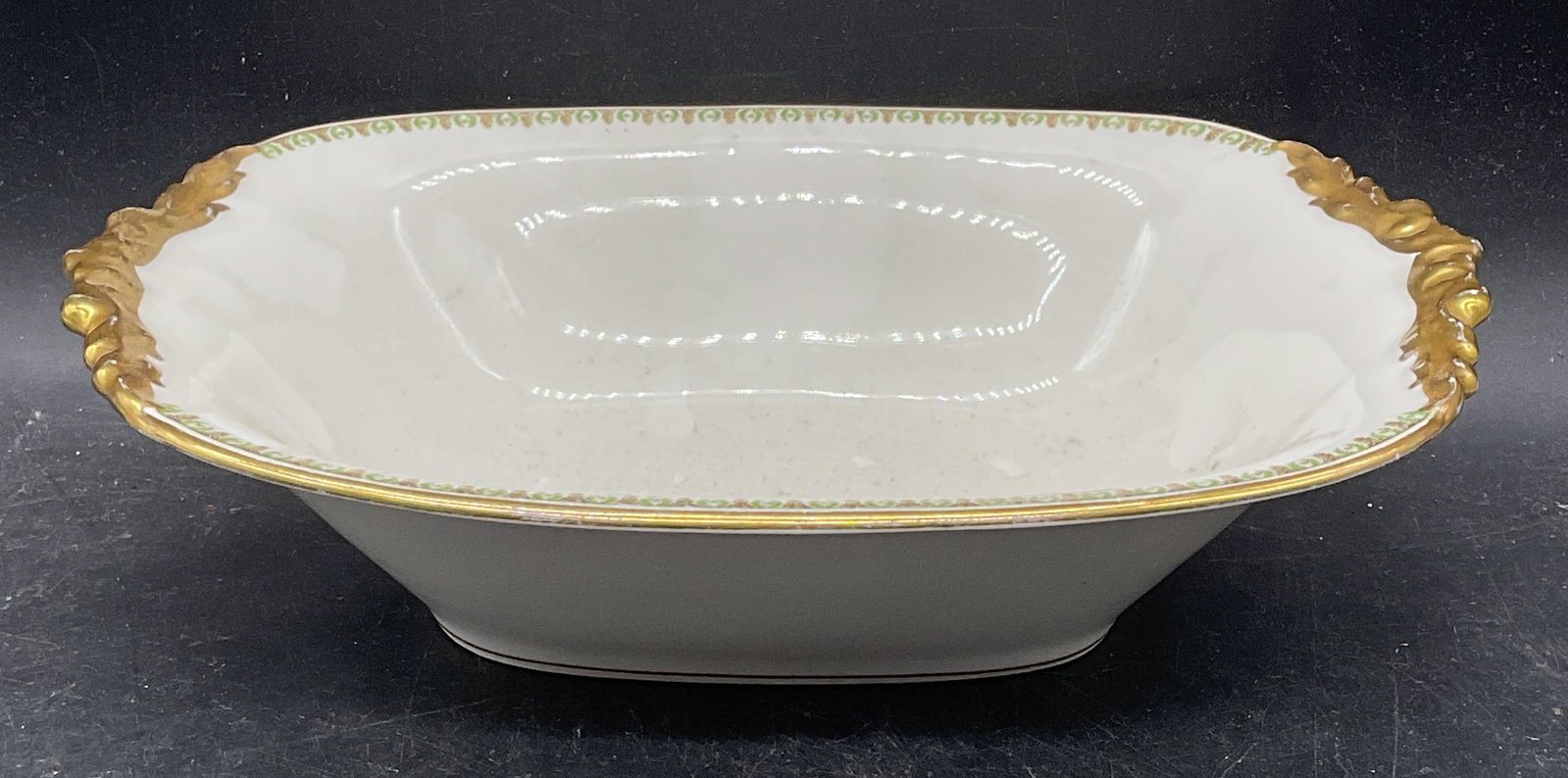 JPL Limoges Porcelain Serving Bowl, France: Vintage JPL Jean Pouyat Limoges porcelain serving bowl. Made in France. Hand painted gilt and floral motif. Measures approx. 10.25 x 7.5 x 2.5 inches. Some scratching and loss to paint. J pouyat