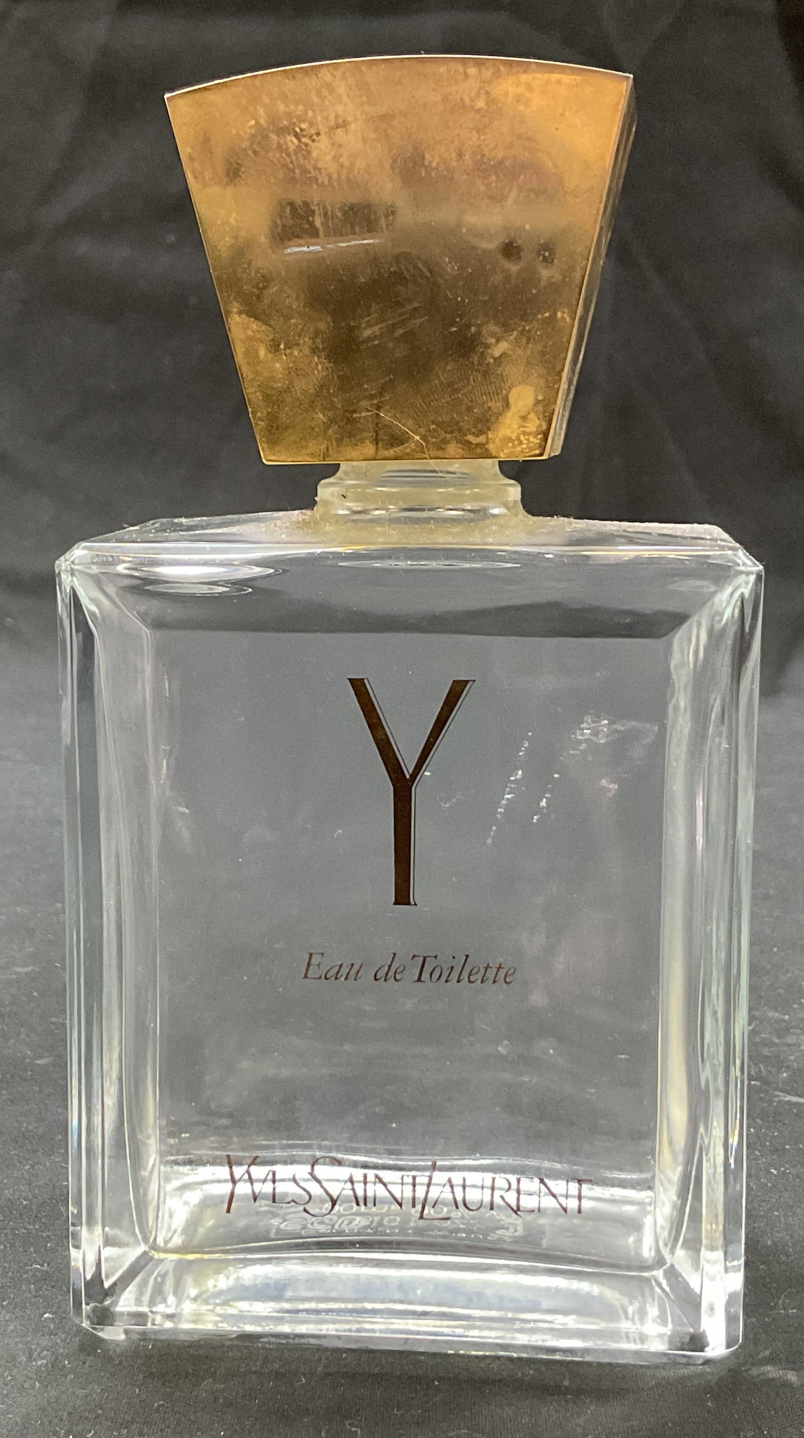 Yves Saint Laurent Glass Perfume Bottle France: Yves Saint Laurent glass perfume bottle. Marked made in France. Square bottle. Gold toned top. Measures approx 2 x 3 x 6 inches. Some scratching. Perfume bottle, accessories, decor, collectibles, YSL.