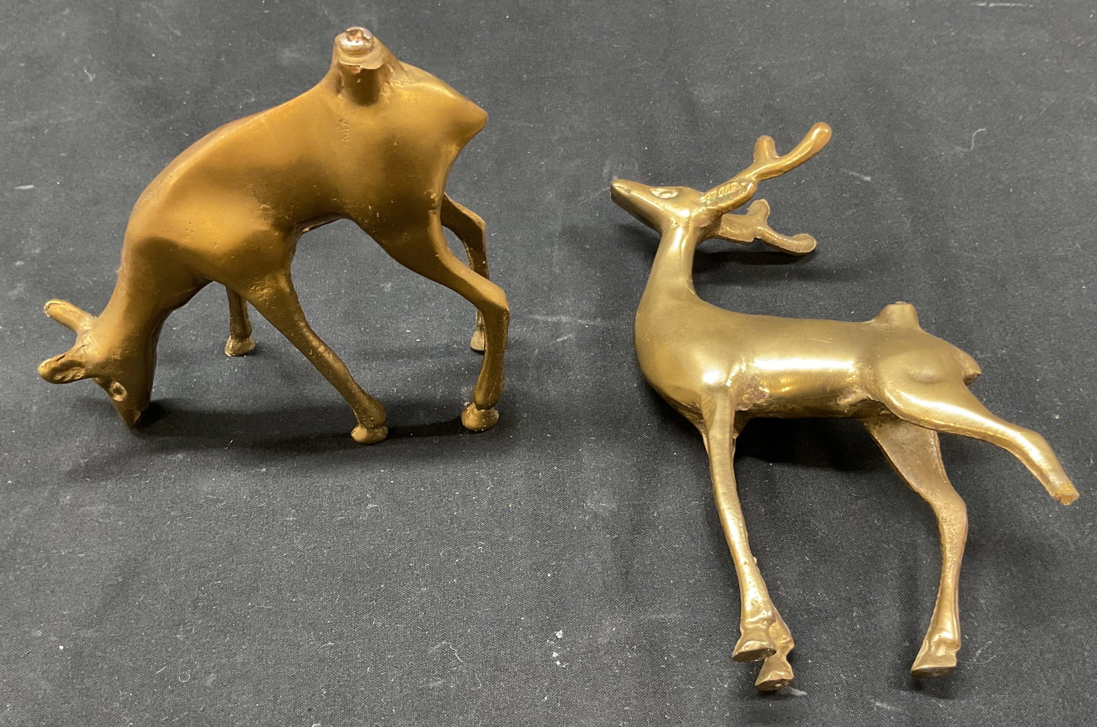Lot 2 Vintage Brass Deer Figures: Lot of 2 items. Vintage brass deer and reindeer figures. Detailed features. Standing figures, one has its head down. Measures approx 1.5 x 3 x 5.5 inches. Losses, missing leg on reindeer. Figures, hom