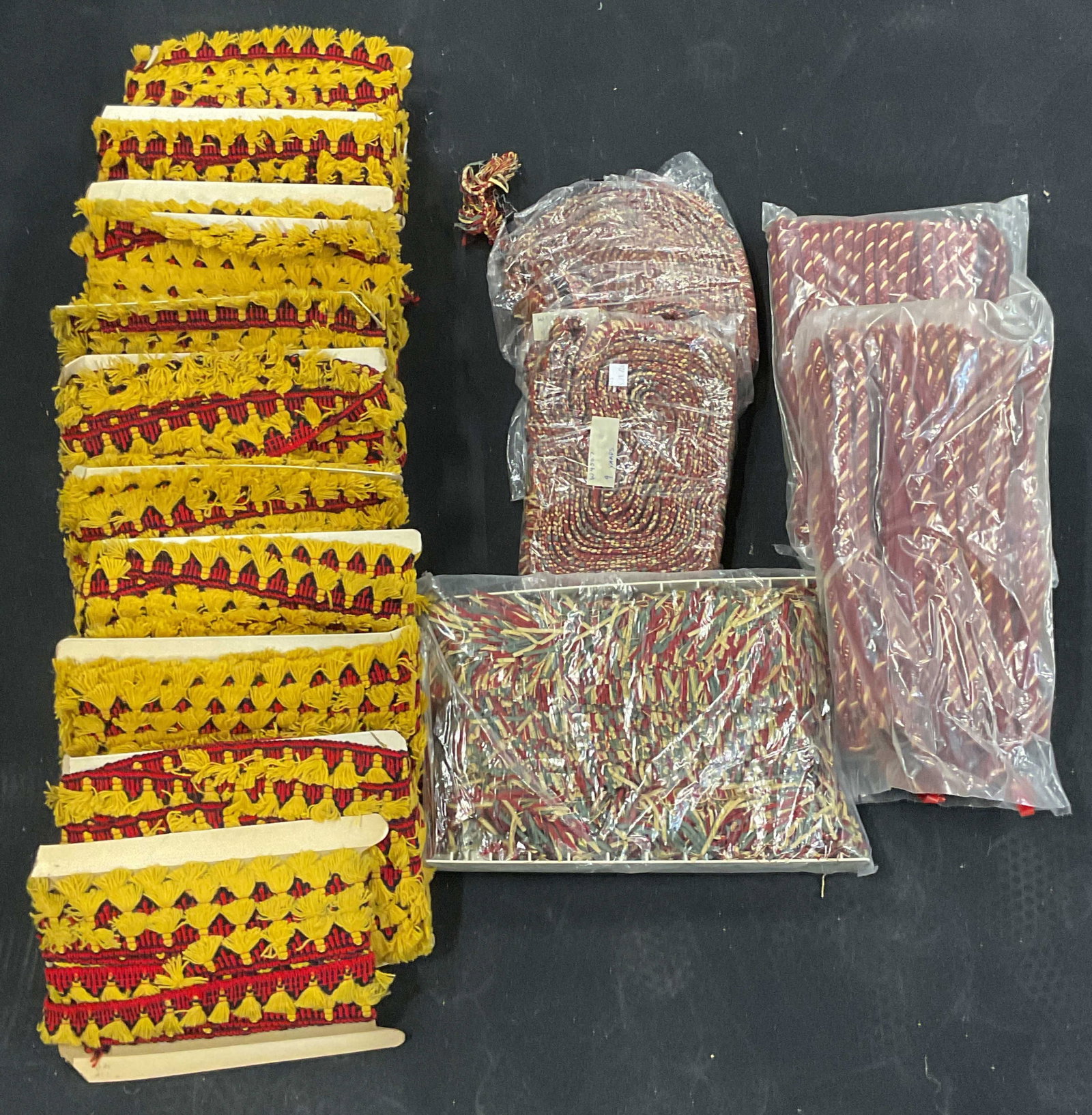 Group Lot Red Gold Tassel Fringe Twisted Trims: Large group lot of assorted trims, twisted fabric, tassel, and fringe in primarily red and gold. Not examined individually. Not measured, yardage unknown. Sold as is. All pieces may have wear consiste