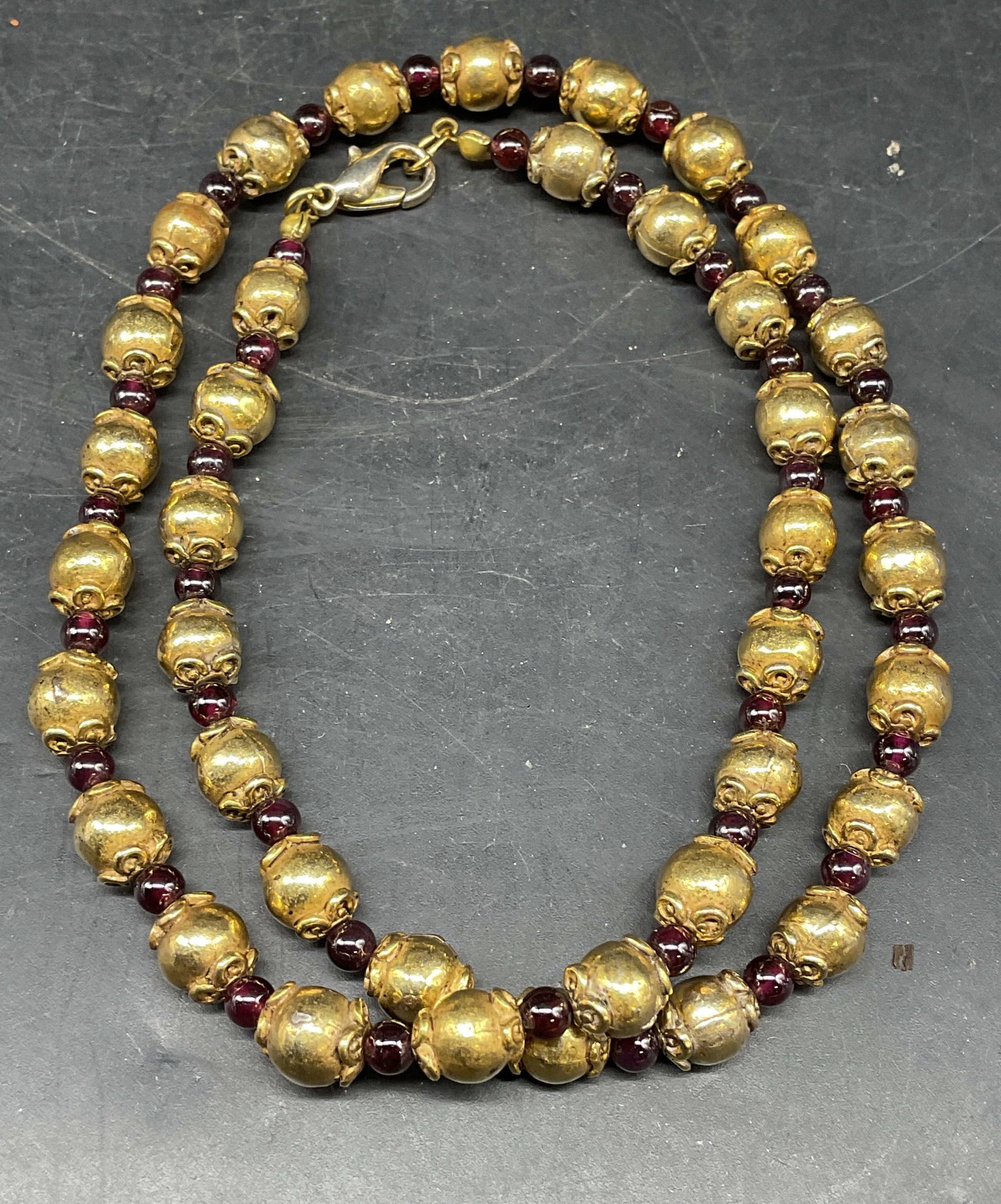 Vintage Gold Tone Purple Beaded Necklace: Vintage gold tone and purple beaded necklace. Drop length measures approx. 9.5 inches. Some scratching and chips. Jewelry, estate jewelry, costume jewelry, cocktail jewelry, fashion jewelry, accessori