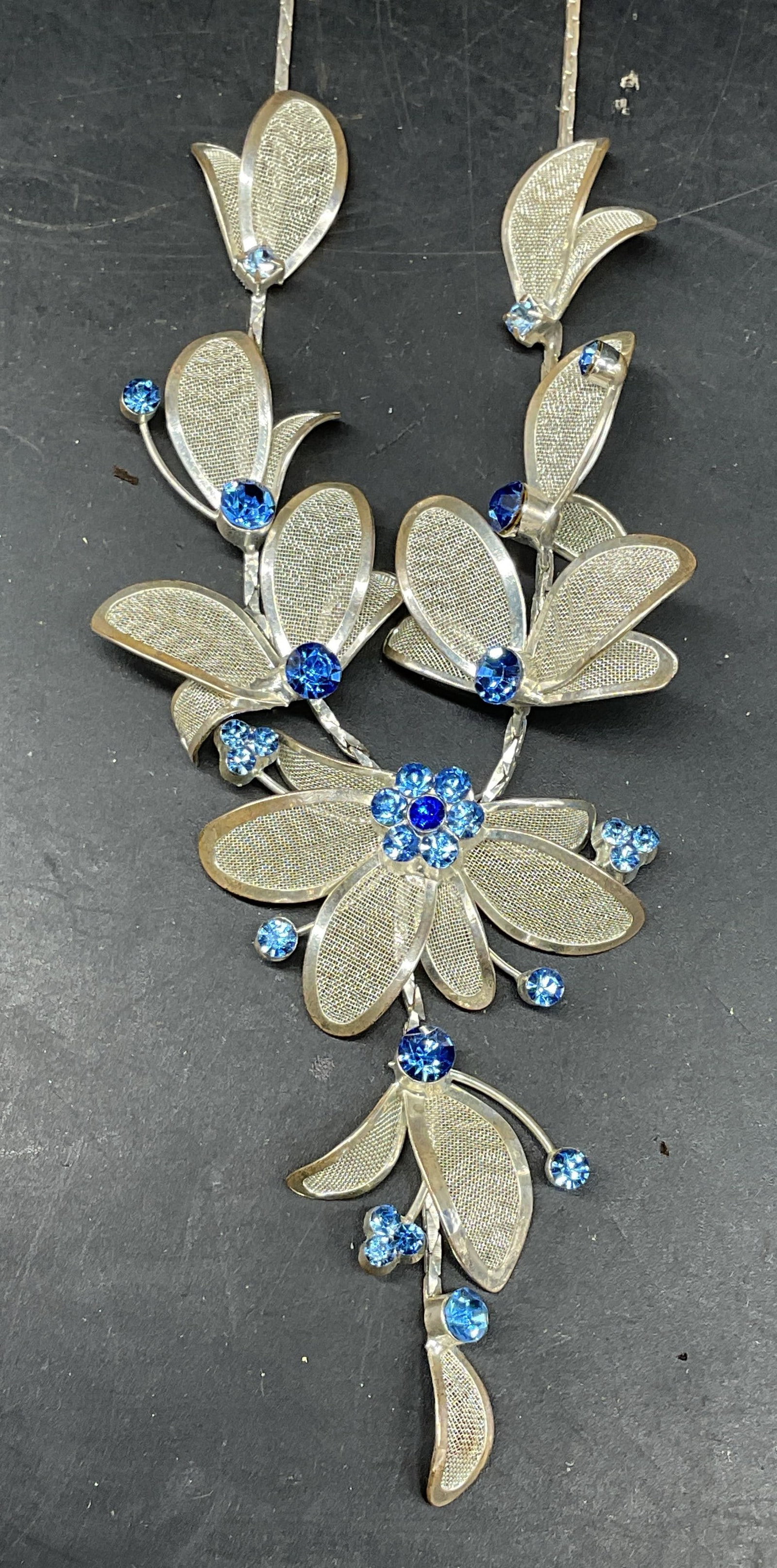 Signed Silver Tone Crystal Flower Necklace: Silver tone blue crystal flower pendant necklace. Signed illegibly. Drop length measures approx. 10 inches. Some scratching. Jewelry, estate jewelry, costume jewelry, cocktail jewelry, fashion jewelry