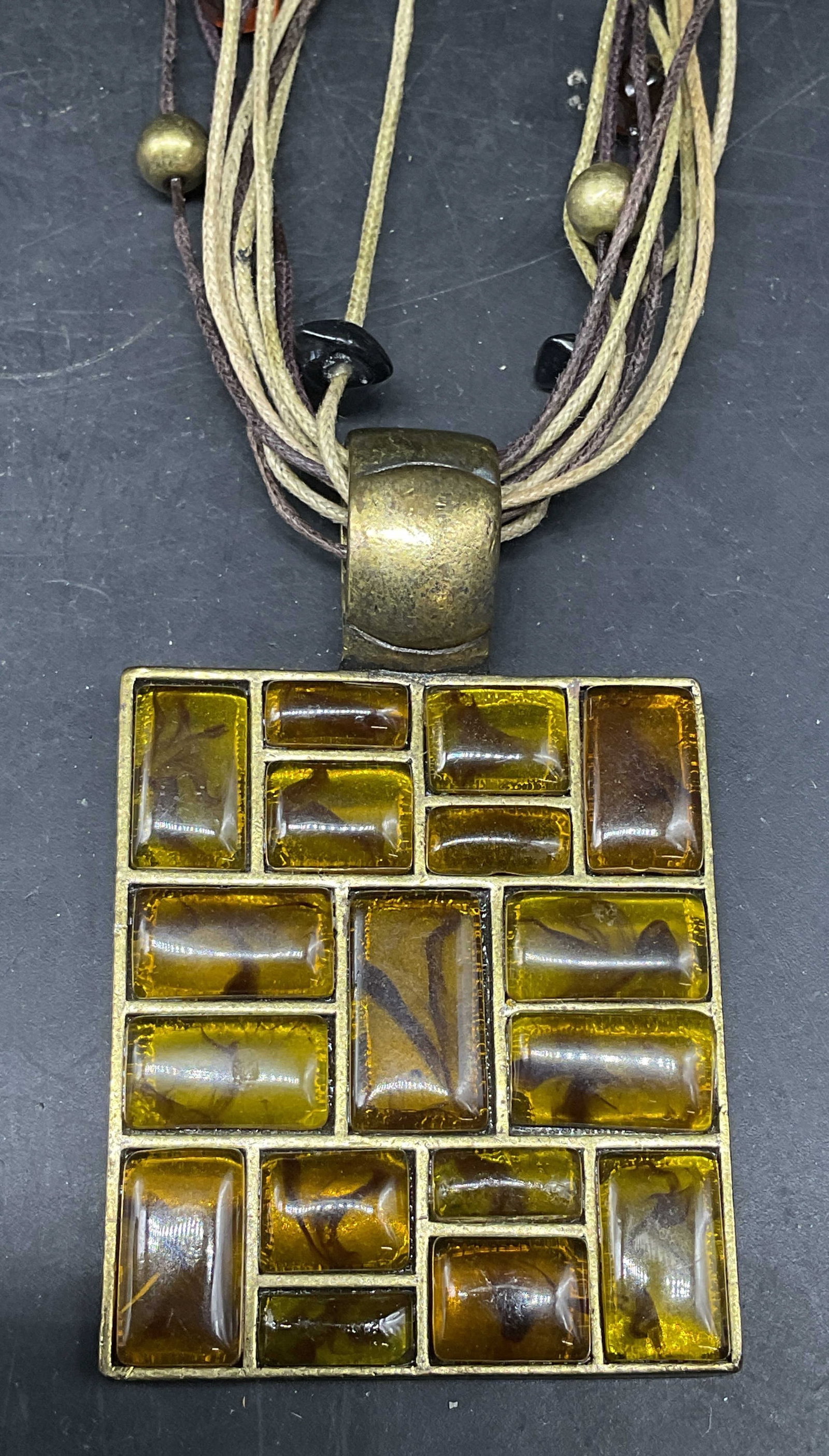 Vtg You & I Gold Tn Amber Lucite Necklace: Vintage signed You & I beaded multi strand necklace with gold tone amber toned lucite pendant. Drop length 8.25 inches. Some scratching. Jewelry, estate jewelry, costume jewelry, cocktail jewelry,