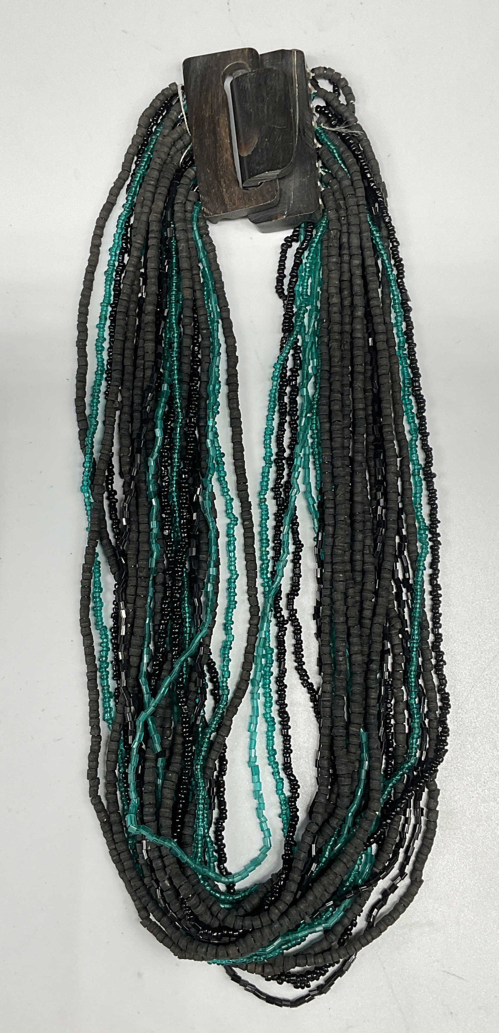 Vintage Blue & Black Beaded Necklace: Vintage blue and black beaded multi strand necklace with carved horn style clasp. Drop length 8 inches. Some scratching. Jewelry, estate jewelry, costume jewelry, cocktail jewelry, fashion jewelry,