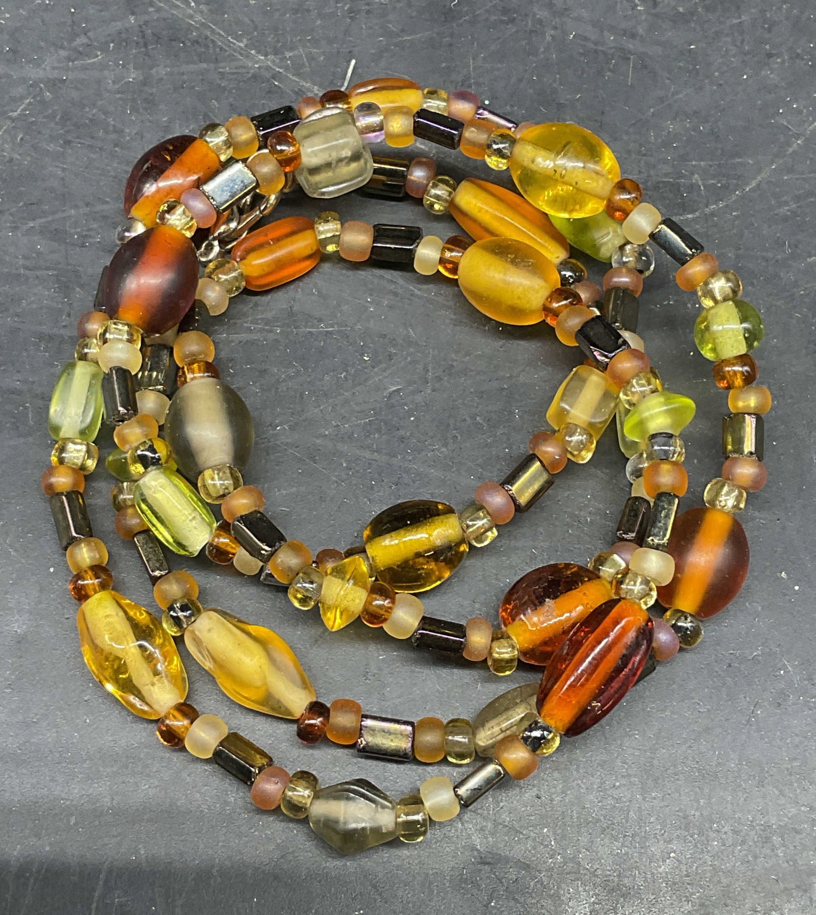 Vintage Green Amber Tone Beaded Necklace: Vintage green and amber toned beaded necklace. Drop length 12 inches. Some scratching. Jewelry, estate jewelry, costume jewelry, cocktail jewelry, fashion jewelry, accessories, fashion accessories, we
