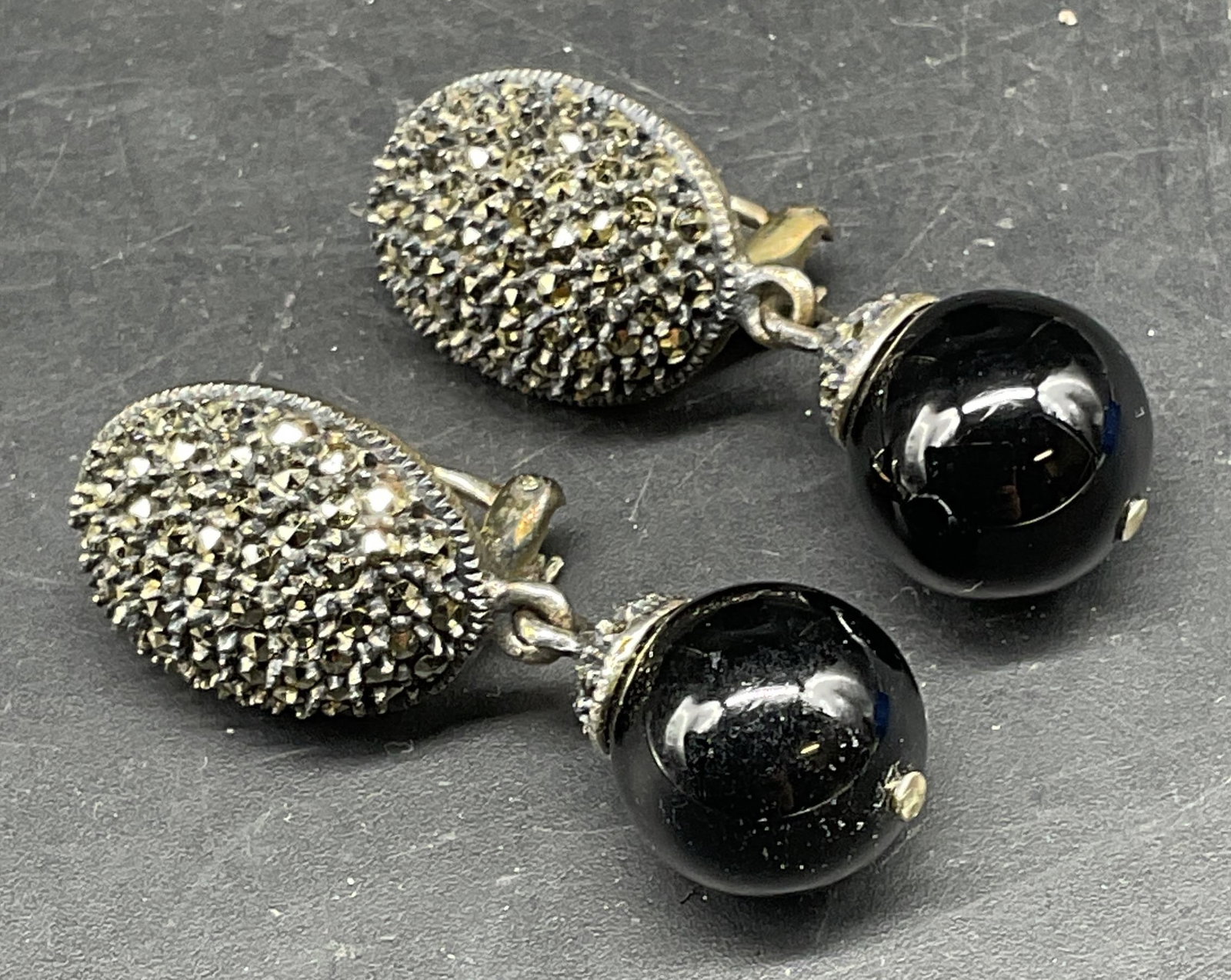 Vtg Sterling Silver Onyx Marcasite Earrings: Vintage sterling silver earrings with onyx beads and marcasite decoration. Marked sterling. Additional mark illegible. Measures approx. 1.5 inches long. Total weight 19.1 grams. Some scratching. Jewel