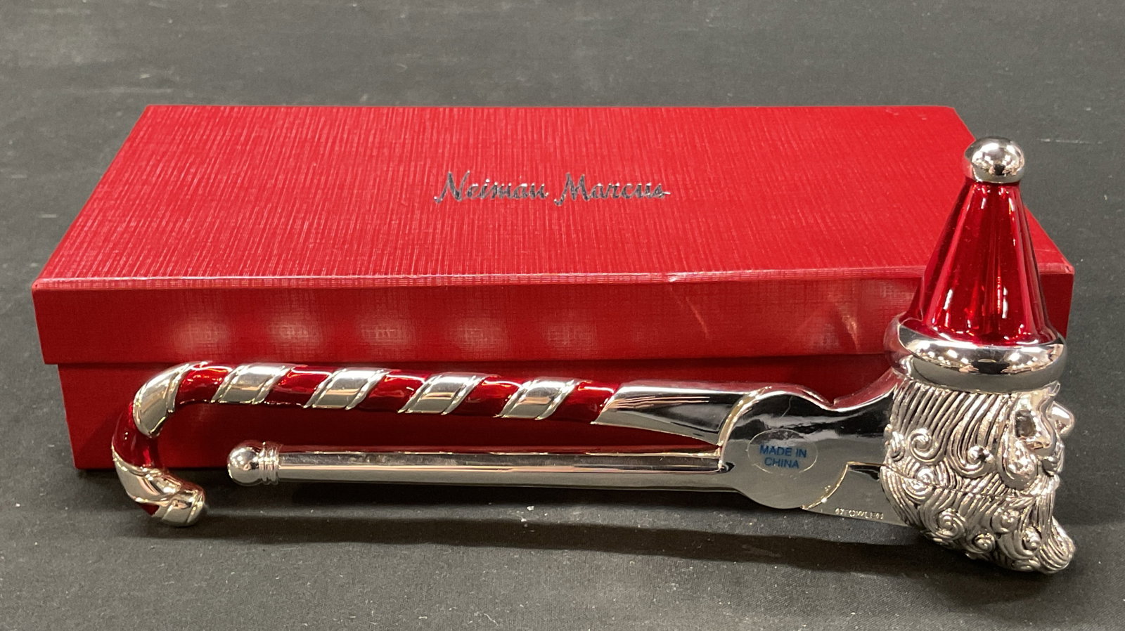 Towle Silver Plated Santa Claus Nutcracker: Towle silver plated Santa Claus nutcracker. Marked Towle on surface. Comes in a Neiman Marcus box. Candy cane handle. Santa Claus figure head. Red accents. Measures approx 7.5 inches in diameter. Surf