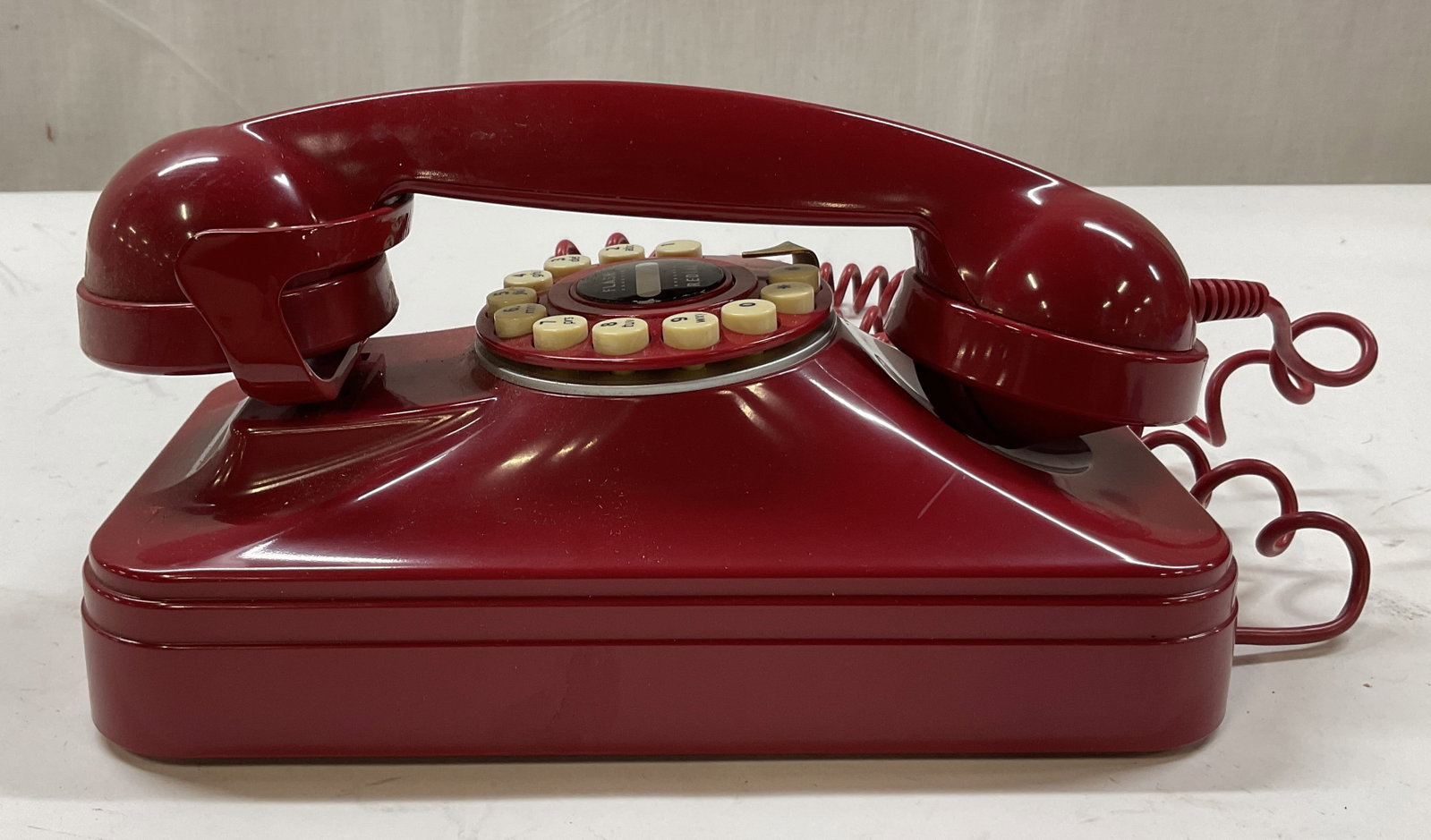 Vintage Red Landline Grand Wall Phone: Vintage red landline grand wall phone. Marked on underside as photographed here. Measures approx 5 x 11 x 3 inches. Not tested for function, sold as is. Surface wear consistent with exposure. Grand wa