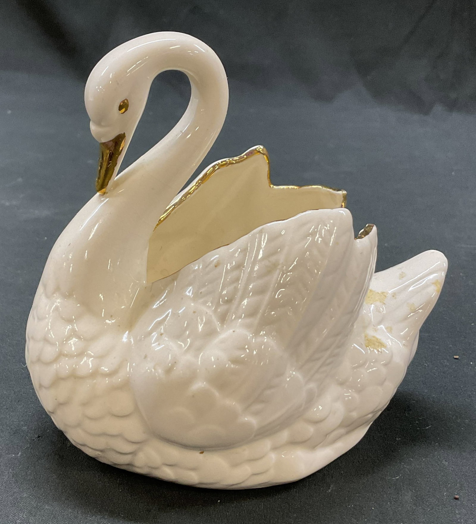Vintage Ceramic Gilt Swan Trinket Dish Holland: Vintage ceramic gilt swan trinket dish. Marked Holland Mold on underside. Swan figure. Gilt accents. Detailed features and textures. Glossy finish. Measures approx 3.5 x 5 x 5 inches. Surface wear con