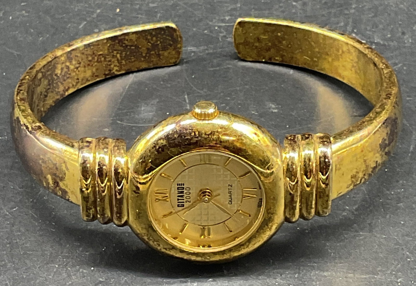 Gitano Gold Tone Bracelet Watch: Signed Gitano gold tone hinged cuff bracelet watch. Measures approx. 2.25 inches wide. Not tested. Some scratching. Jewelry, estate jewelry, costume jewelry, cocktail jewelry, fashion jewelry, accesso