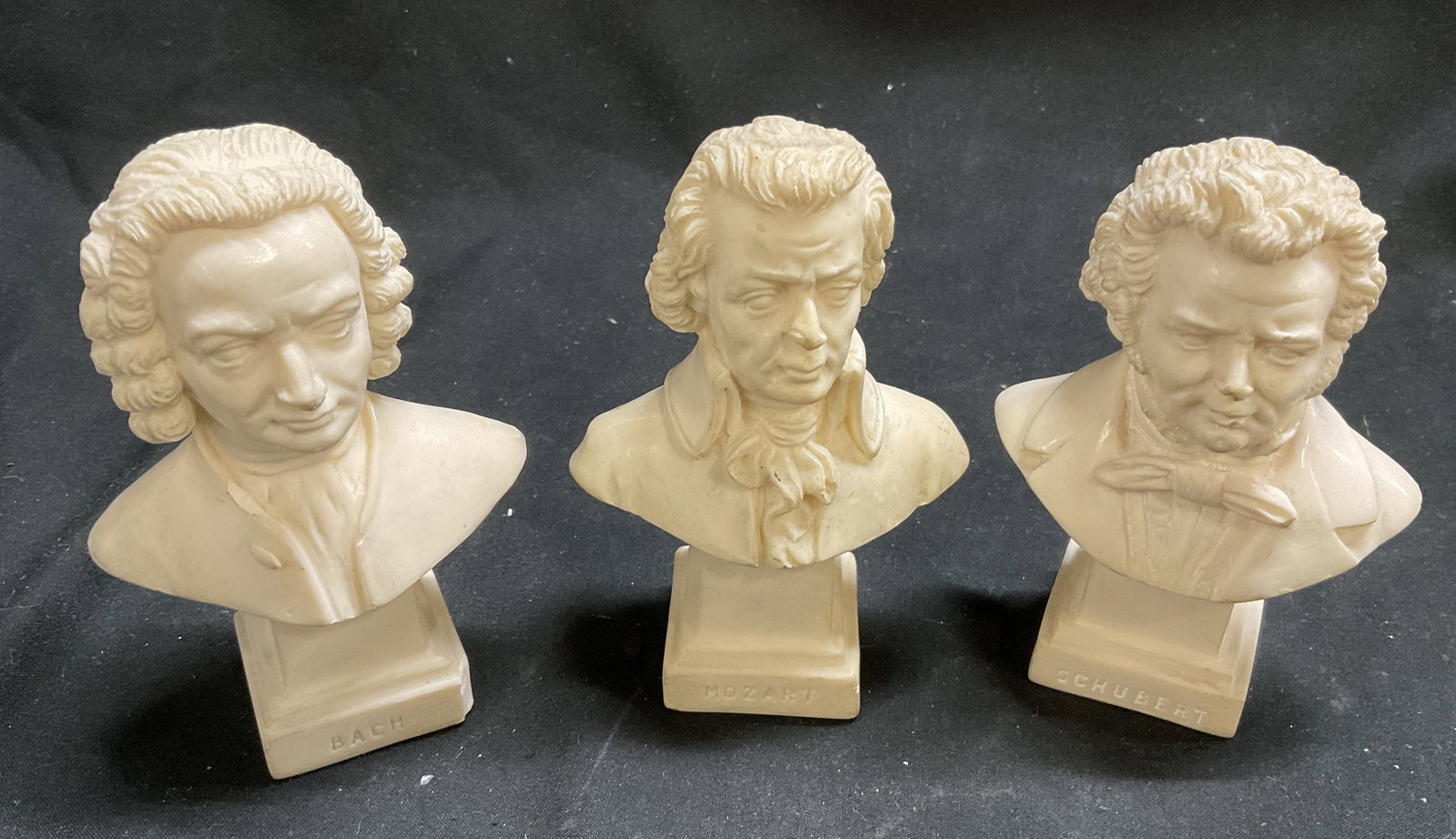 St 3 Composer Mini-Bust Statues: St 3 Composer Mini-Bust Statues. Includes Bach, Mozart, and Schubert. Composite Material. Back reads G R. Some Chipping. Measures app 4in H. Composers, Statues, Busts, Musicians, Classical Music, Musi