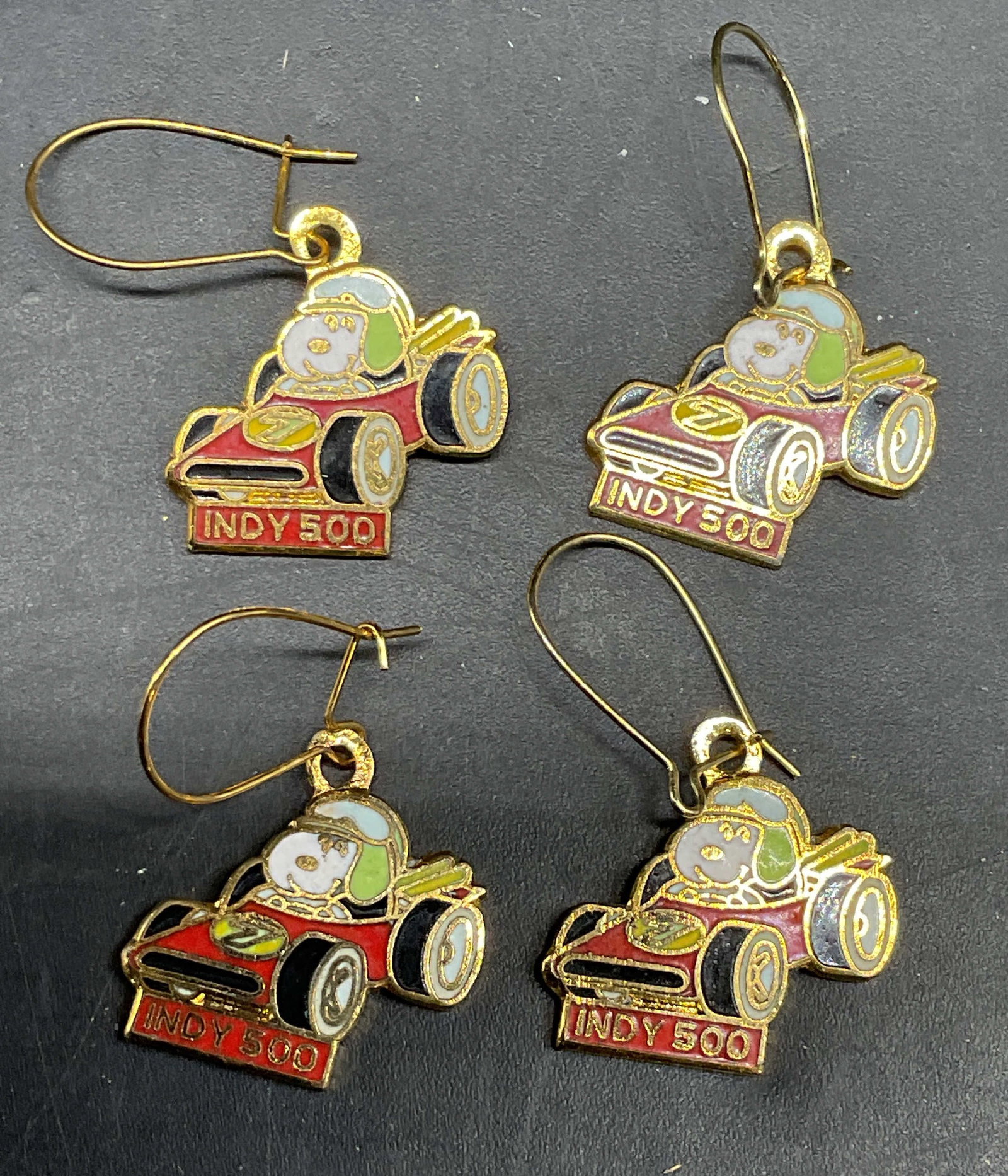 Lot 2 Aviva Snoopy Indy 500 Enamel Earrings: Lot of 2 pairs of vintage signed Aviva gold tone enameled Peanuts Snoopy Indy 500 race car earrings. Measures approx. .75 inches wide. Some scratching. Jewelry, estate jewelry, costume jewelry,