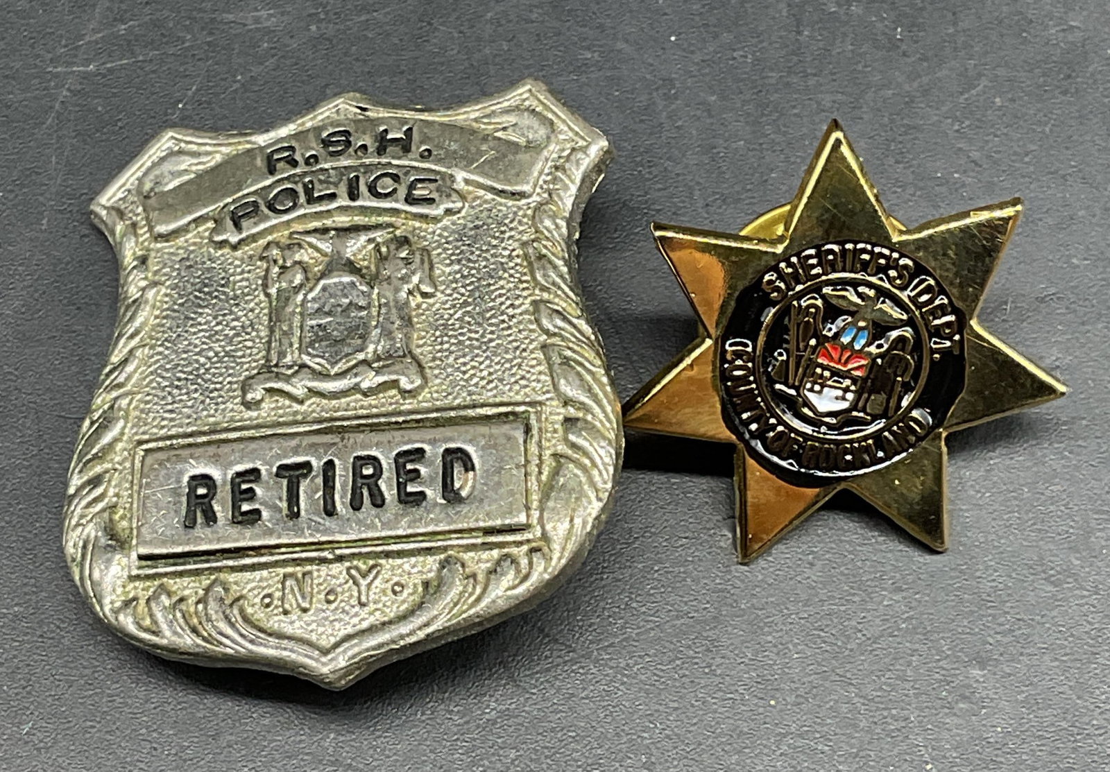 Lot 2 Silver & Gold Tn Police & Sheriff Pins: Lot of 2 silver and gold tone police and sheriff motif pins. Larger measures approx. 1.25 x 1 inches. Some scratching. Jewelry, estate jewelry, costume jewelry, cocktail jewelry, fashion jewelry,