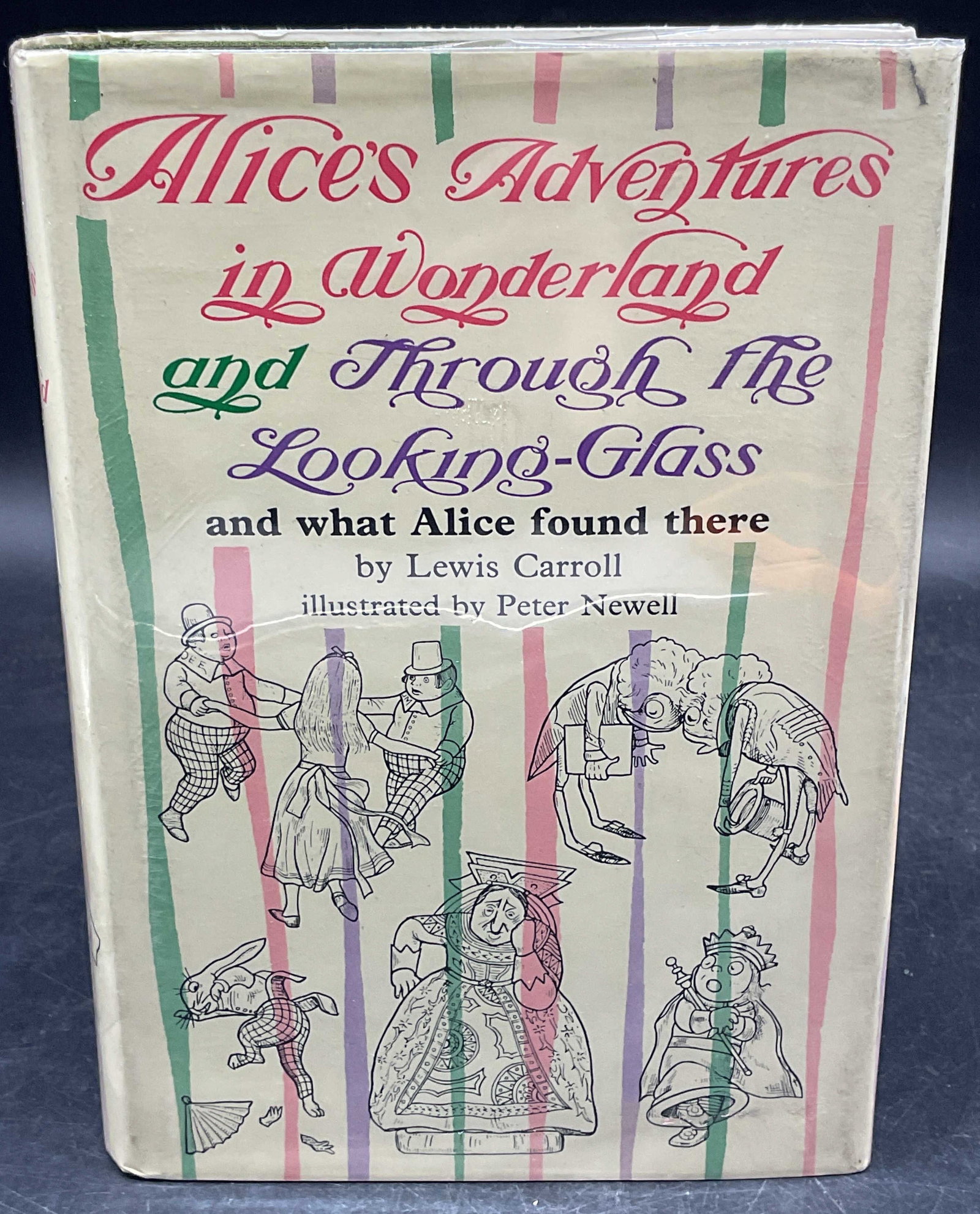 1968 Carroll Alice & Looking Glass Illustr Newell: Hardcover copy of Alices Adventures In Wonderland and Through The Looking Glass by Lewis Carroll. Tuttle, 1968. Printed in Japan. Illustrated by Peter Newell. Measures approx. 8.75 x 6.25 inches. Wear