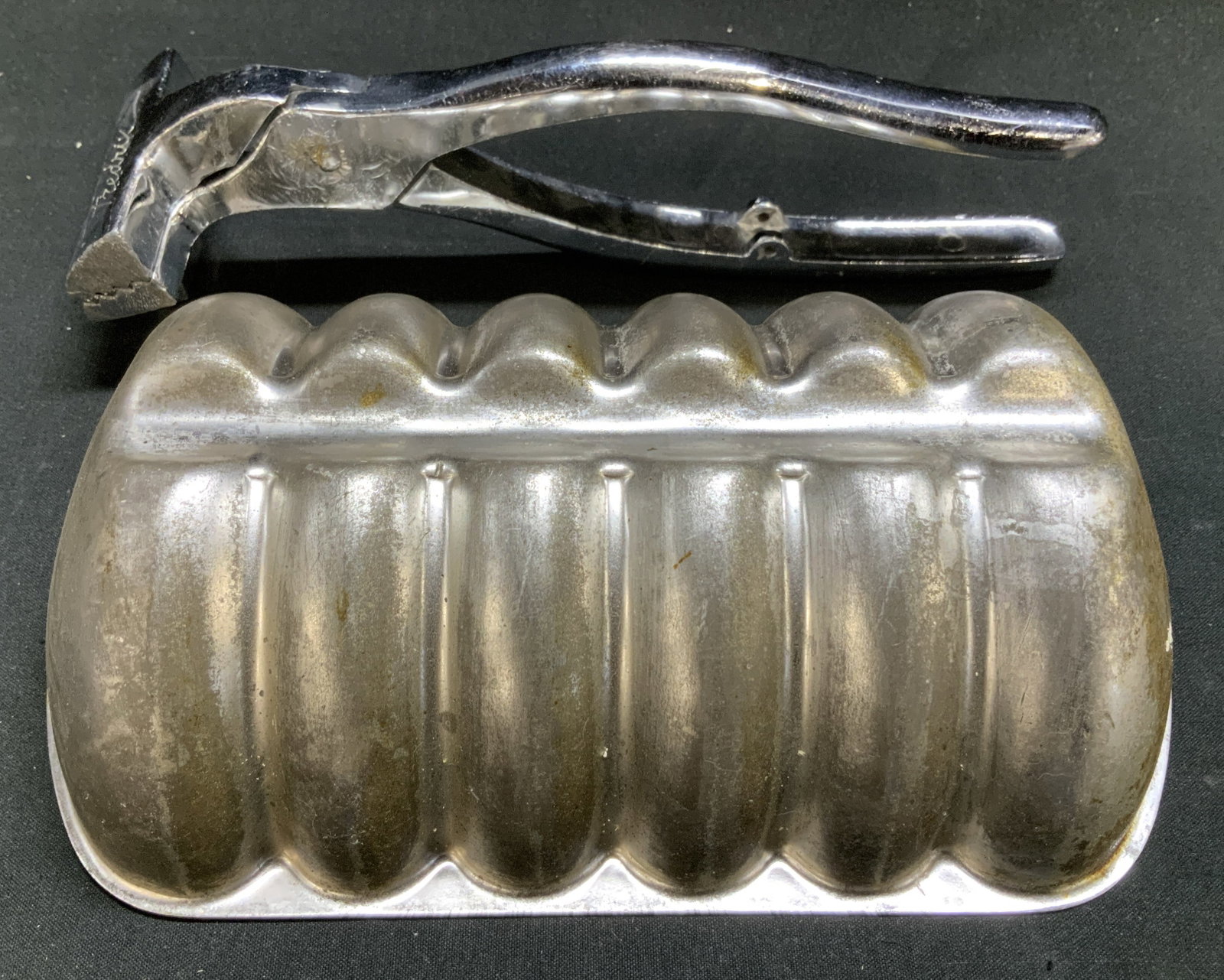 Lot 2 Silver Toned Jello Mold & Fredrix Pliers HG: Lot includes, 1 silver toned Jello mold & 1 Fredrix canvas stretching pliers. Sold as is. Property of opera singers estate from the renowned & opulent Manhattan landmark. The Ansonia. Surface wear con