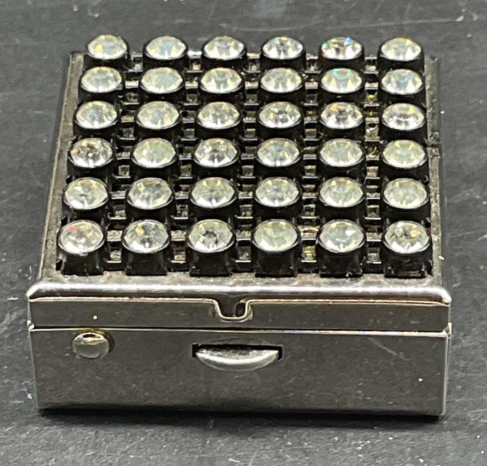 Silver Tone Crystal Trinket Box: Silver tone trinket box with crystal decorated lid. Measures approx. 1.25 x 1.25 x 5/8 inches. Some scratching. Jewelry, estate jewelry, costume jewelry, cocktail jewelry, fashion jewelry, accessories