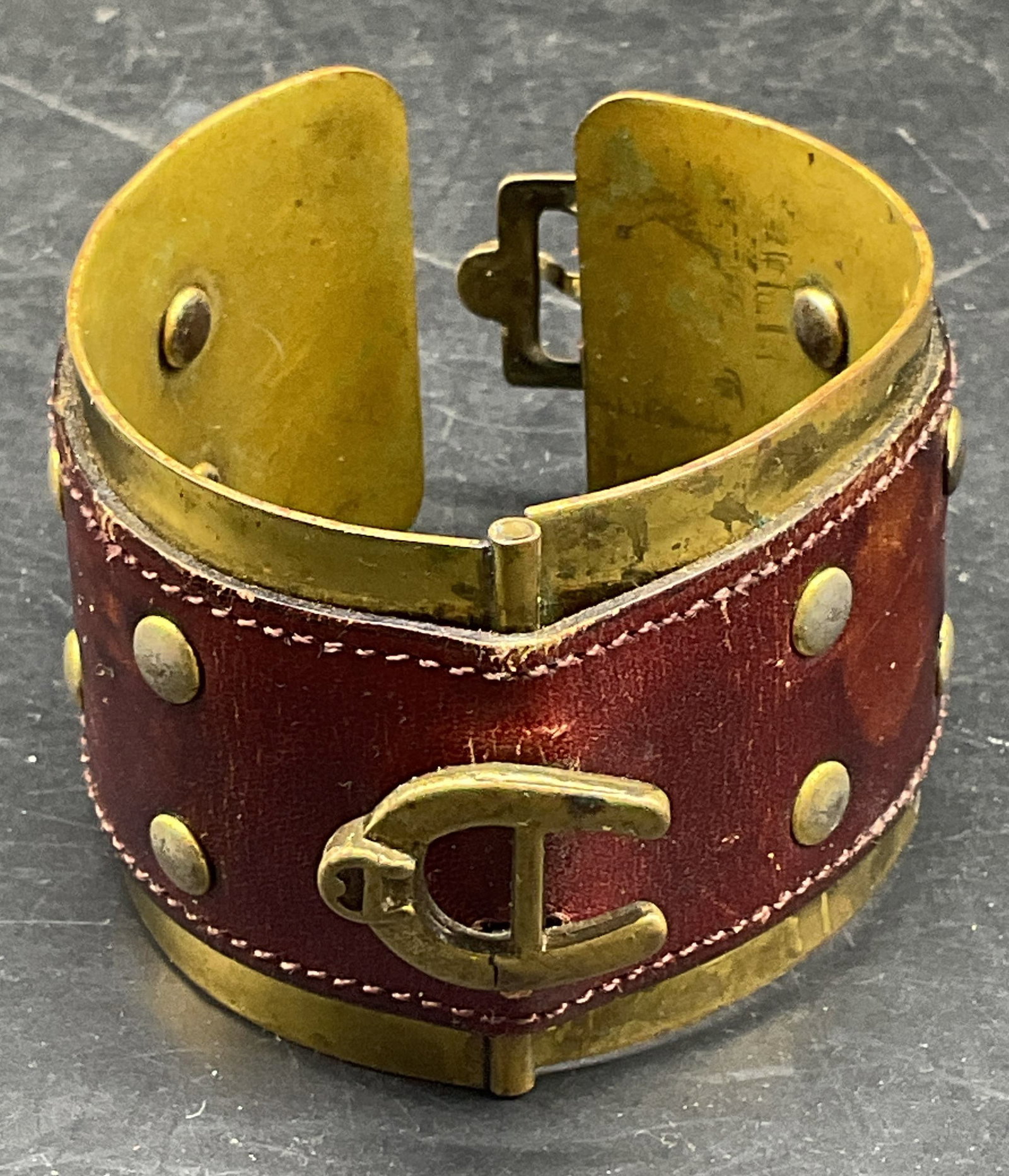 Vintage Brass & Leather Horseshoe Bracelet: Vintage leather over brass hinged cuff bracelet with buckle and horseshoe motif. Measures approx. 2.25 inches wide. Some scratching. Jewelry, estate jewelry, costume jewelry, cocktail jewelry, fashion