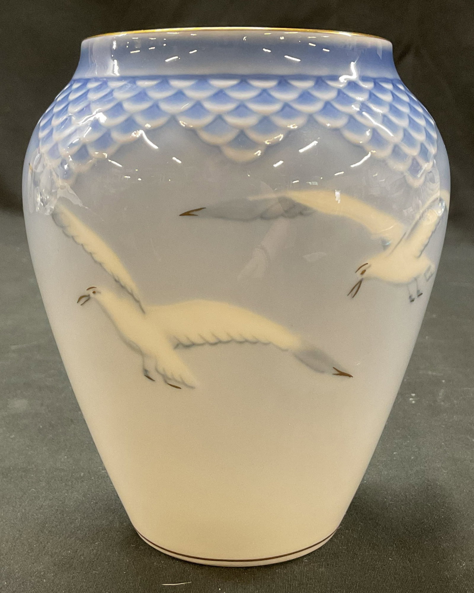 Bing & Grondahl Porcelain Seagull Vase Denmark: Bing & Grondahl porcelain seagull vase. Marked on underside, reads B&G Copenhagen Porcelain Made In Denmark. Bulbous shape. Gilt rim. Hand painted white seagulls. Blue background with geometric patter