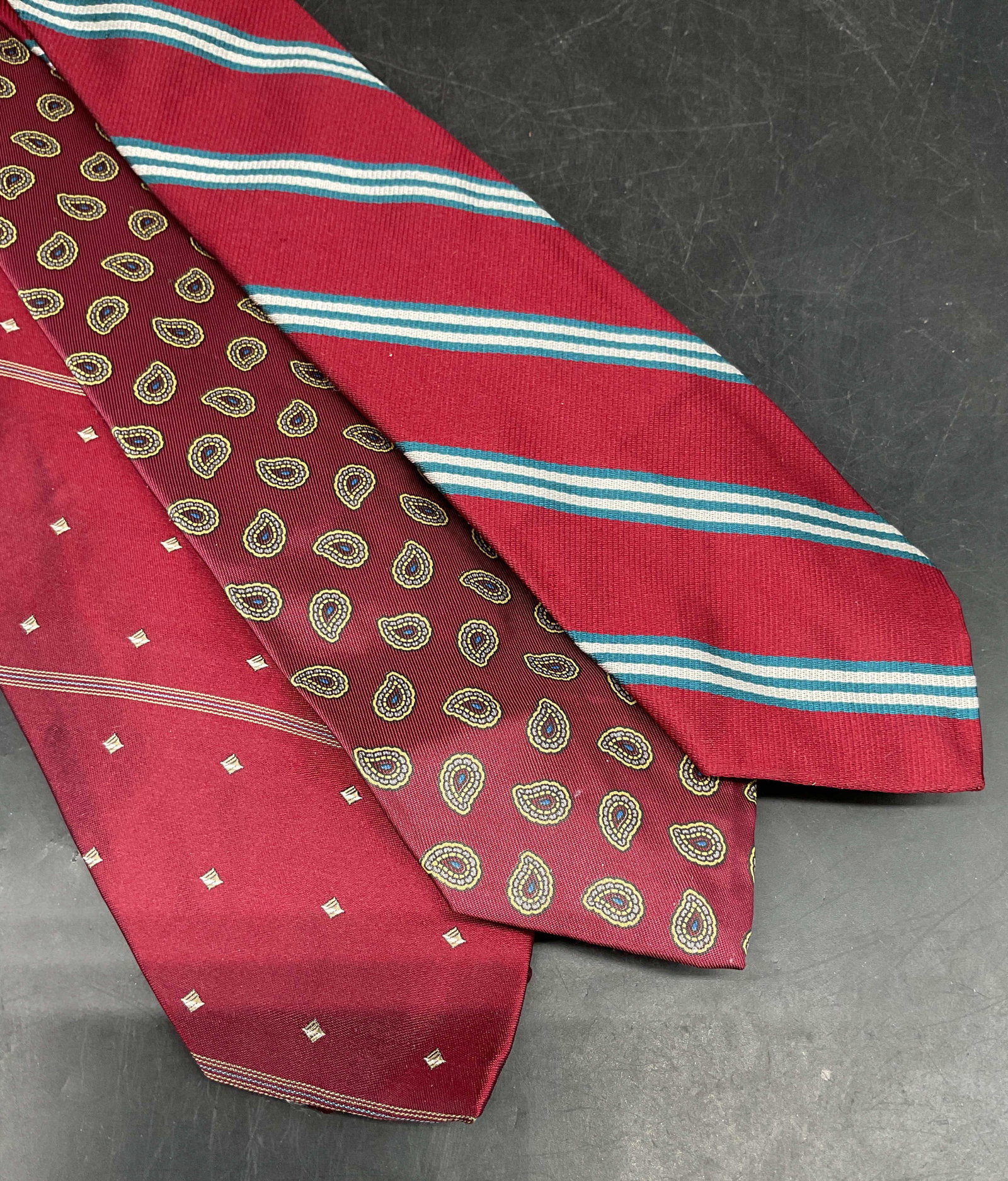 Lot 3 Red Silk Geometric Striped Silk Tie Italy +: Lot of 3 red ties. Geometric striped silk tie, woven in Italy. Bancroft paisley print tie and Bert Pulitzer striped tie, synthetic materials. Longest measures approx. 58 inches. Some blemishes. Tie, s