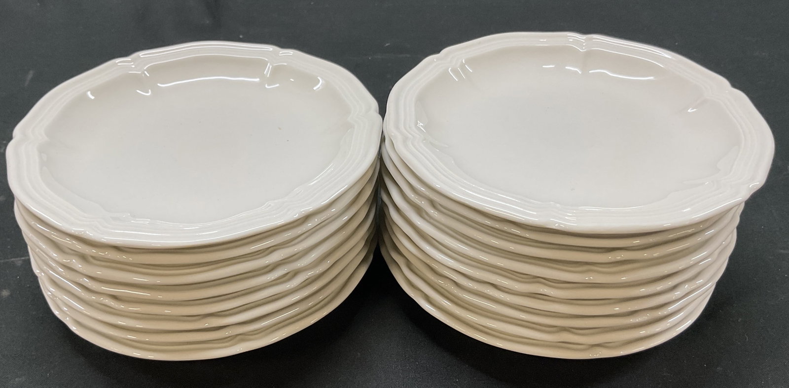 Set 17 Villeroy & Boch Porcelain Small Plates: Set of 17 Villeroy & Boch porcelain small plates. Marked on underside as photographed here. Round plates with scalloped edge. Ribbed surface. Measures approx 5 inches in diameter. Surface wear consist