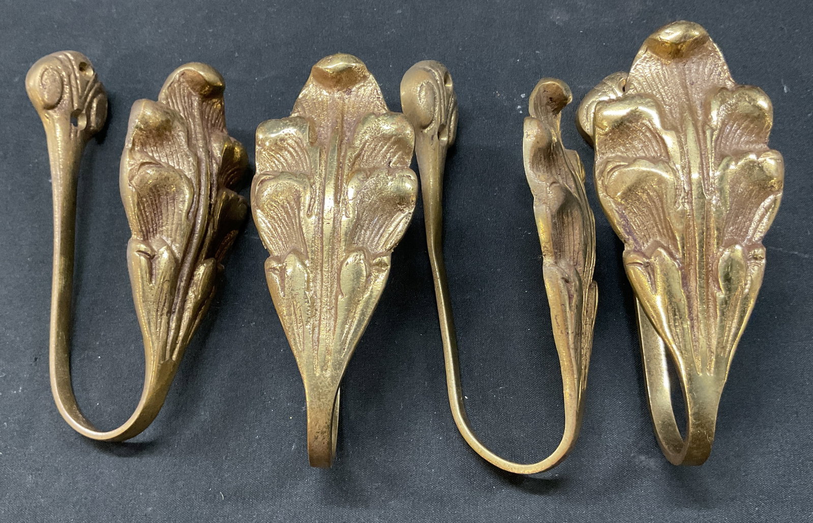 Set 4 Vintage Brass Leaf Tie Backs: Set of 4 vintage brass leaf tie backs. Scalloped and ribbed surface. Leaf motif. Holes for mounting. Measures approx 2 x 5 inches. Surface wear consistent with exposure. Tie backs, decor, home decor,