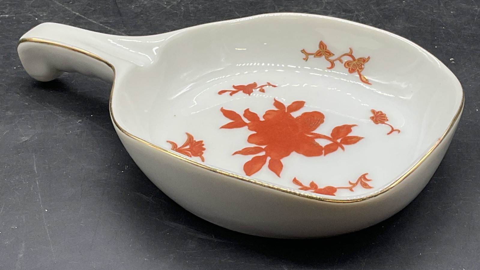 Vintage LJ Porcelain Floral Trinket Dish: Vintage LJ porcelain trinket dish with handle. Hand painted and gilt floral design. Measures approx. 4.25 x 6.75 x 1 inches. Some scratching and loss to paint. LJ trinket dish, porcelain trinket dish,