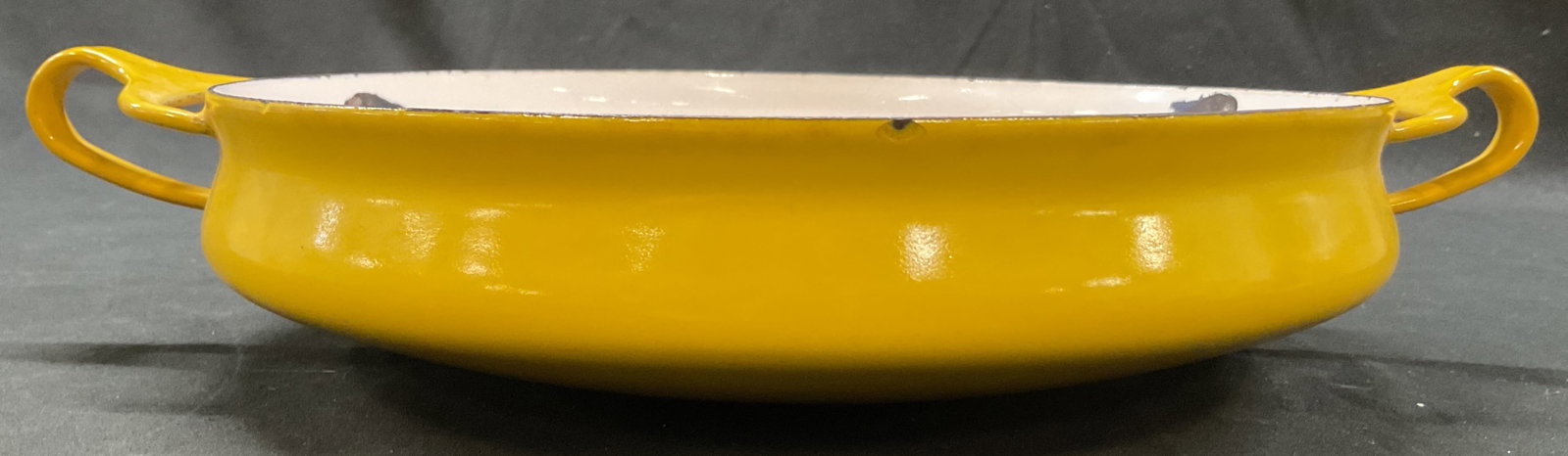 Dansk Kobenstyle Yellow Enamelware Pan France: Dansk Kobenstyle yellow enamelware pan. Marked on underside, reads Dansk Designs France. Bright yellow color. Handles on either side. Circular shape. Measures approx 10 x 13 x 2.5 inches. Scratching. 