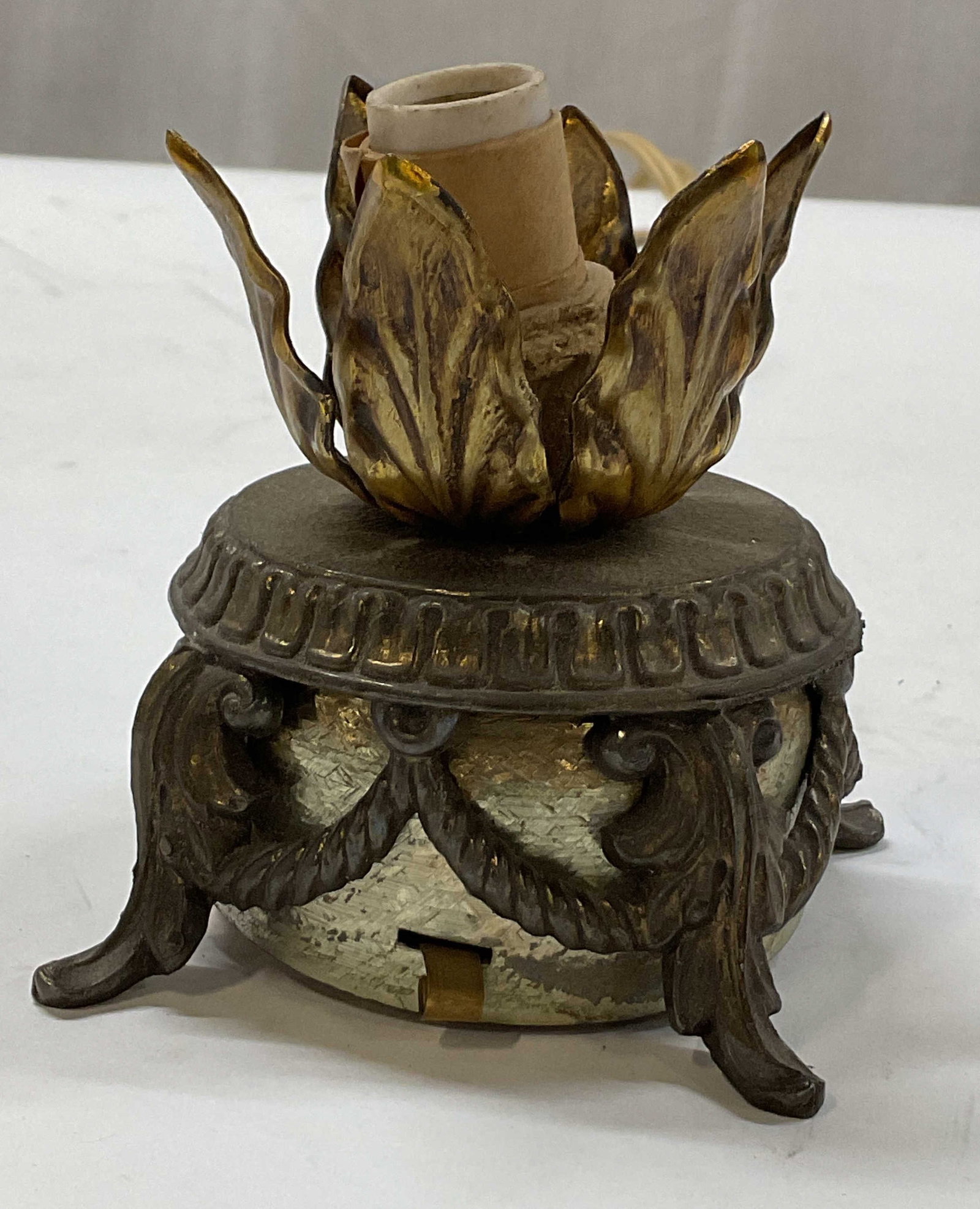 Vintage Cast Metal Music Box Lamp: Vintage cast metal music box lamp. Footed base. Scalloped leaf accents. Gold toned with patina. Measures ht approx 3.5 inches diam approx 3 inches. Not tested for function, sold as is. Loose pieces. M