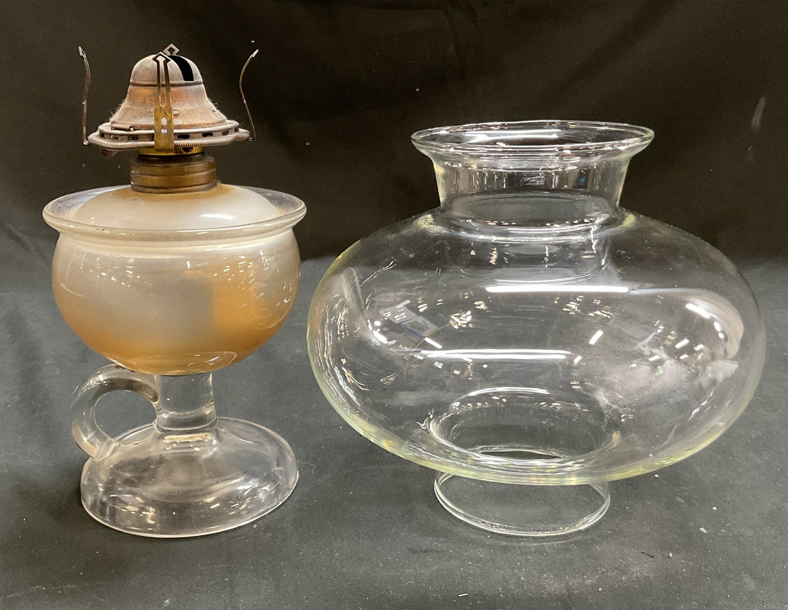 Antique Glass Oil Lamp W Hurricane Cover: Antique glass oil lamp. Round base. Integrated handle. Wide top. Comes with bulbous shaped hurricane cover. Measures ht approx 8 inches diam approx 4.5 inches. Not tested for function, sold as is.