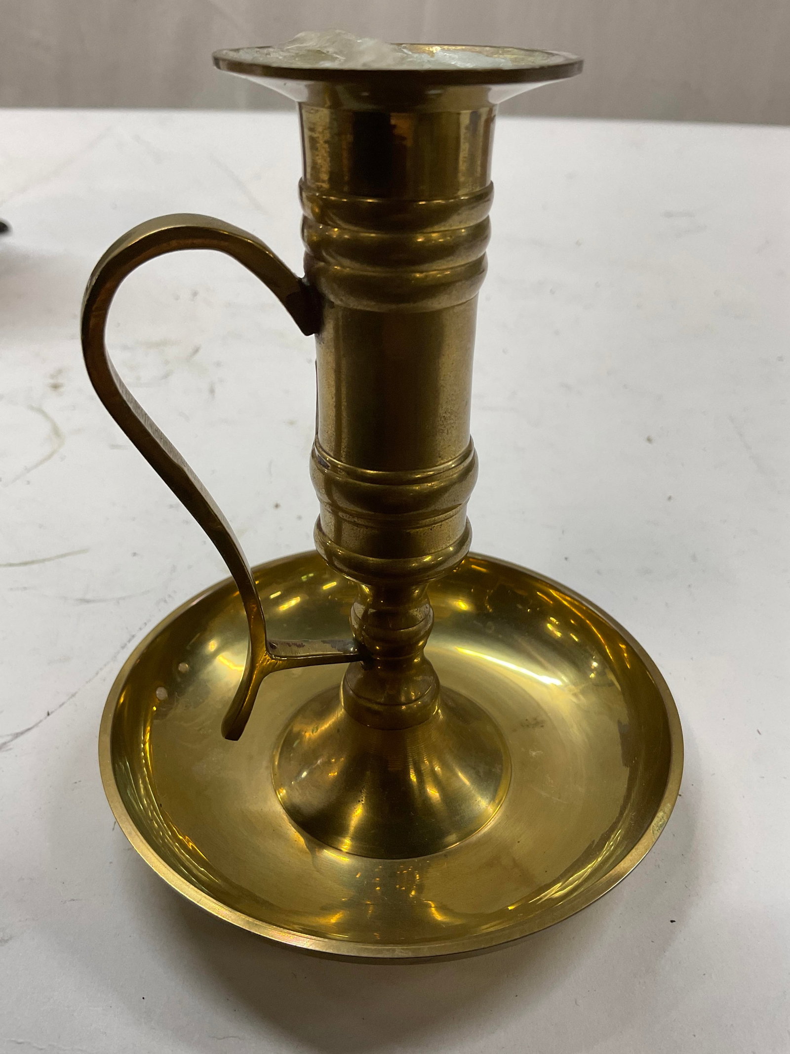 Brass Chambers tick Candle Holder with Loop: Candle stick holder with finger loop holder classic colonial style silhouette, tray like cylindrical base and push up center, measures ht app 5 inches, base diameter app 4 inches