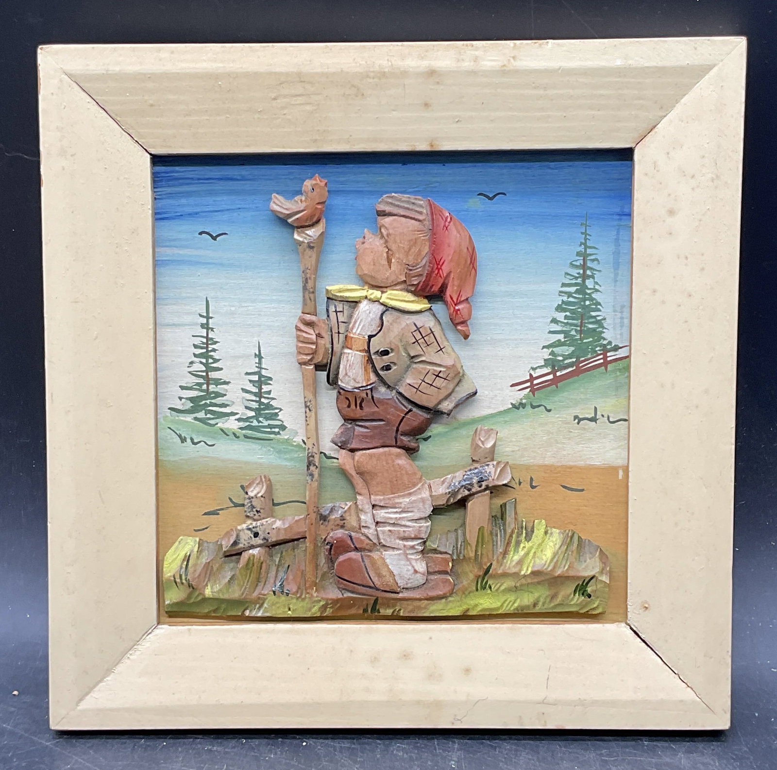 Hand Painted Carved Wood Boy Bird Relief: Hand painted and carved wood relief. Boy with bird and landscape. Wood frame. Not examined out of frame. Marked Italy on reverse. Frame measures approx. 8 x 8 inches. Some scratching. Art, framed art,
