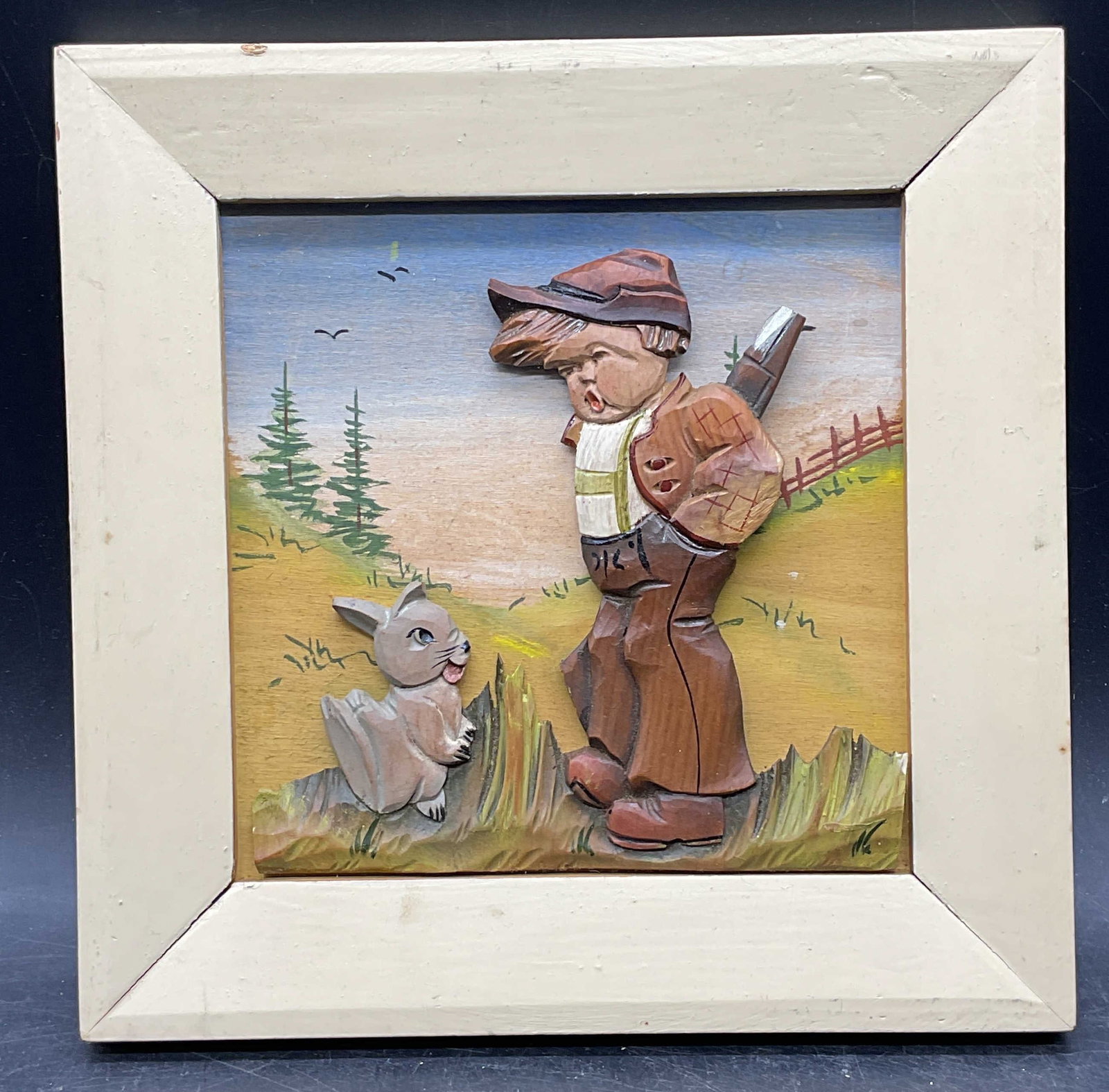Hand Painted Carved Wood Boy Rabbit Relief: Hand painted and carved wood relief. Boy with rabbit and landscape. Wood frame. Not examined out of frame. Frame measures approx. 8 x 8 inches. Some scratching. Art, framed art, wood relief, home deco