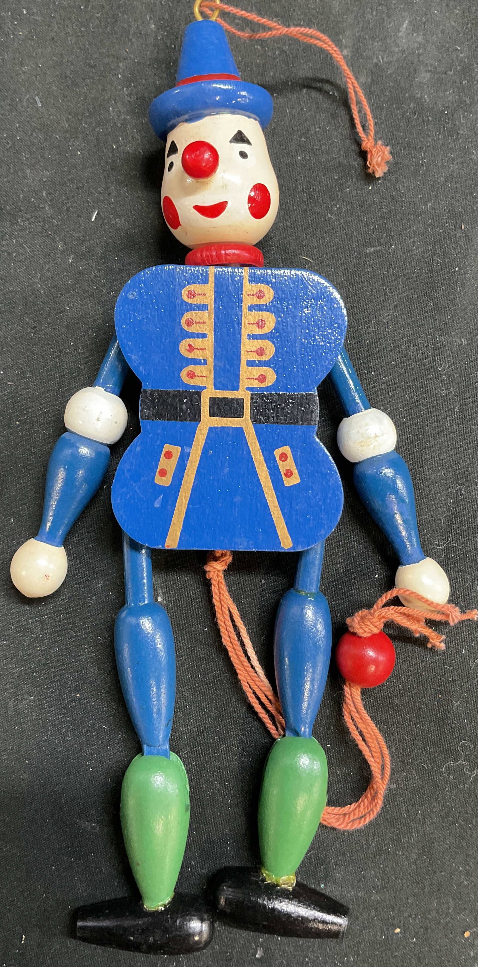 Vntg Wood Jumping Jack Pull String Toy: A vintage blue wood jumping jack pull string toy clown and ornament . The clown features a blue hat, red nose, and blue jacket with yellow trim, pull string puppet , Hampelman in European folk art, st
