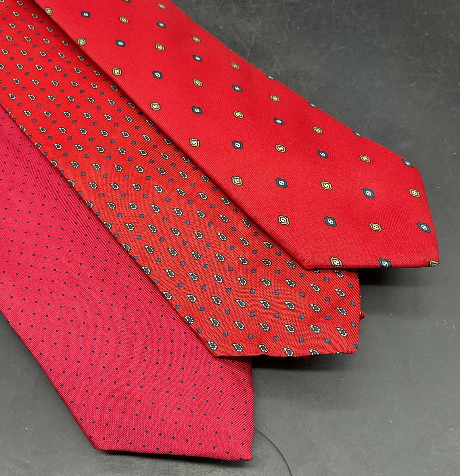 Lot 3 Bert Pulitzer + Red Silk Ties: Lot of 3 red silk ties with graphic prints. Bert Pulitzer, Pietro di Como, and John Henry. Longest measures approx. 56 inches. All have some blemishes. Tie, red tie, silk ties, accessories, fashion ac
