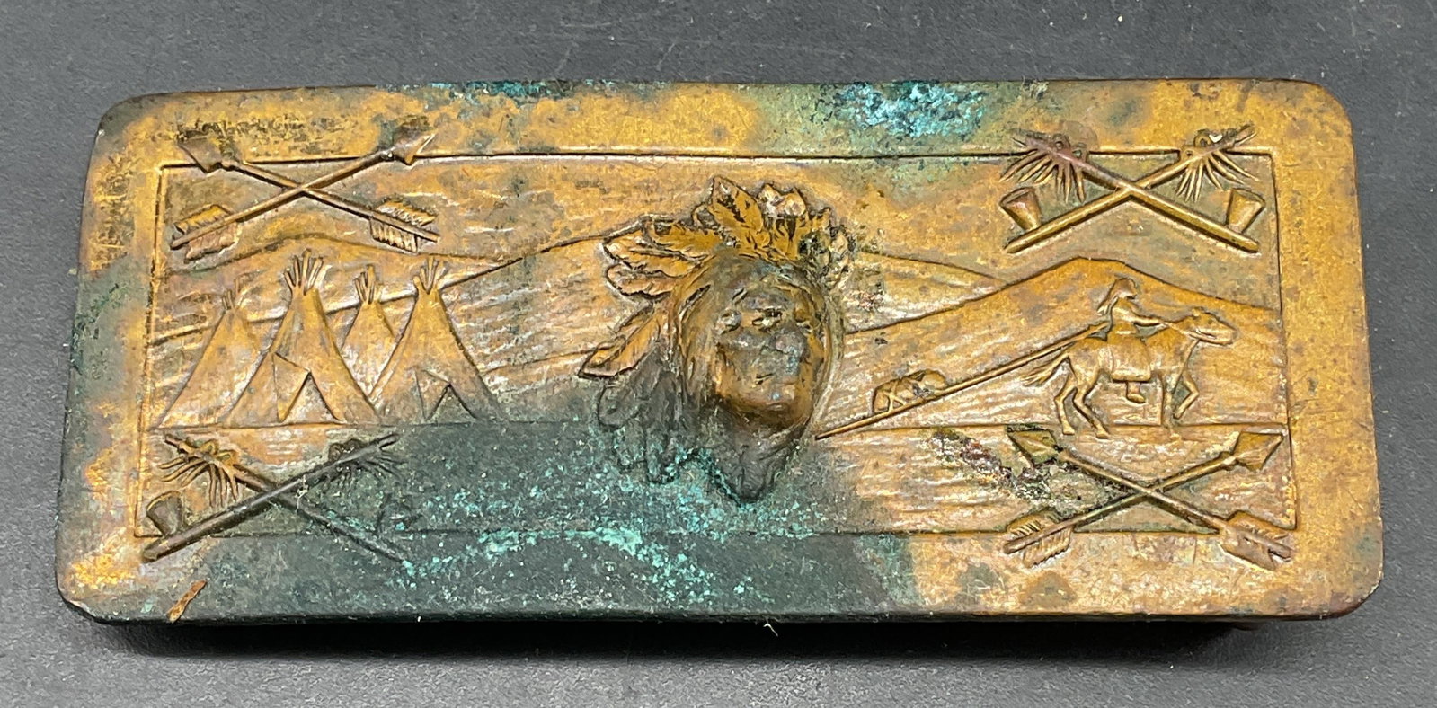Vintage Robbins Co Brass Chief Belt Buckle: Vintage Robbins Co brass belt buckle with raised Native American chief motif. Measures approx. 3 x 1.25 inches. Wear including patina and scratching. Robbins co belt buckle, chief belt buckle, native