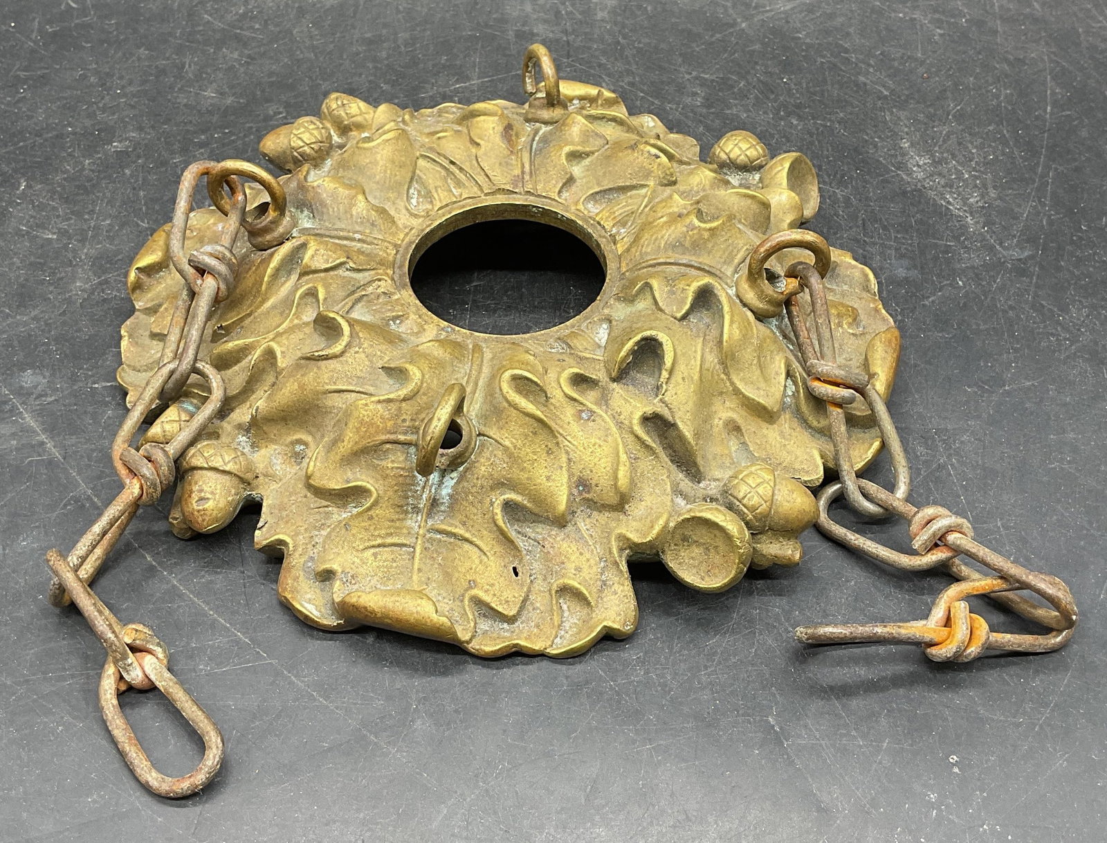 Vintage Brass Acorn Light Fixture Hardware: Vintage brass light fixture hardware. Raised acorn and leaf motif. Piece has weight. Measures approx. 7.5 inches wide. Wear including patina and scratching. Light fixture hardware, brass hardware, hom